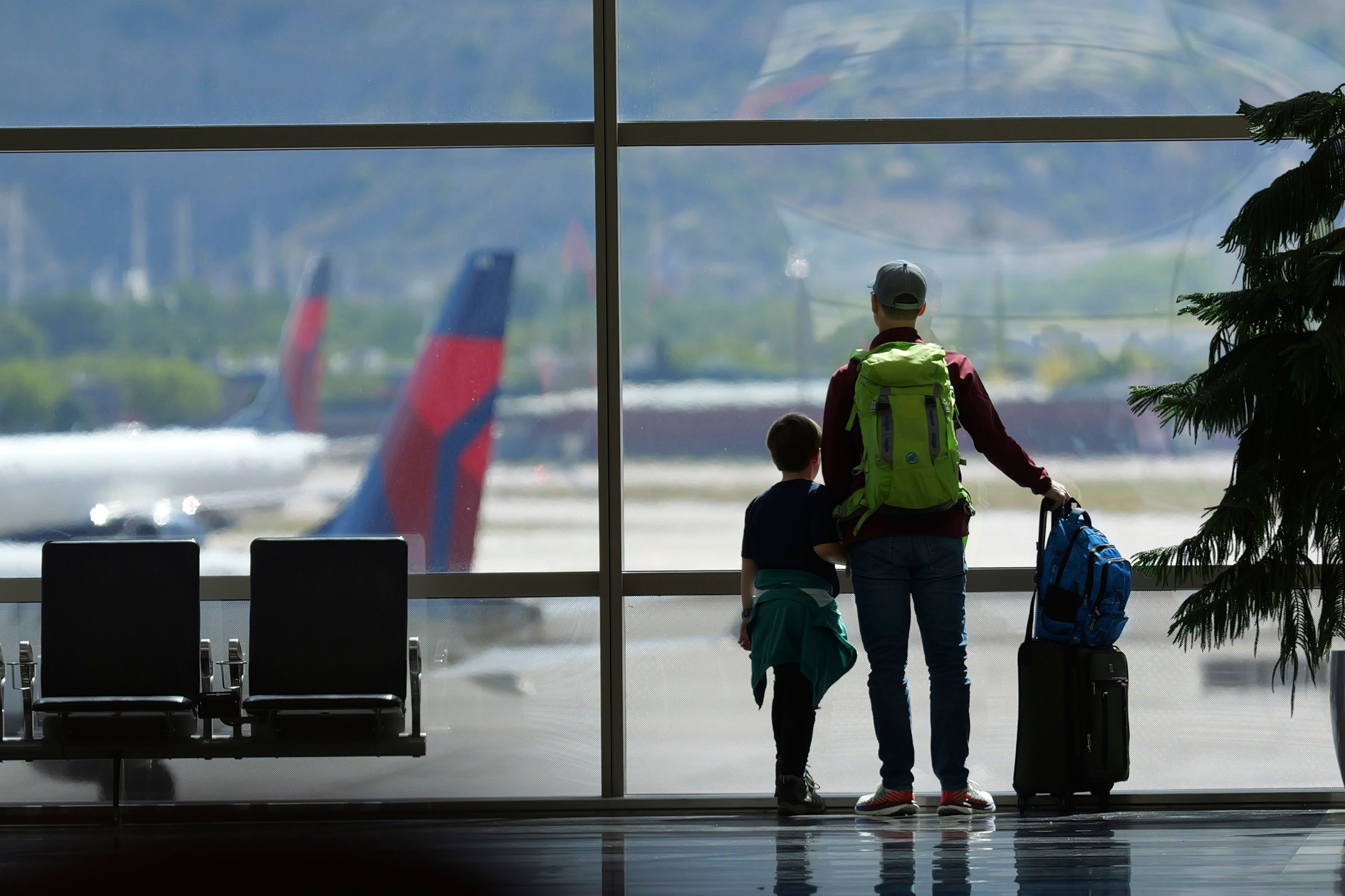 FTravelers pass through Salt Lake City International Airport on May 24 in Salt Lake City. On Thursday, Transportation Secretary Pete Buttigieg announced a new rule that would require airlines to do everything possible to ensure parents can sit with young children on flights.