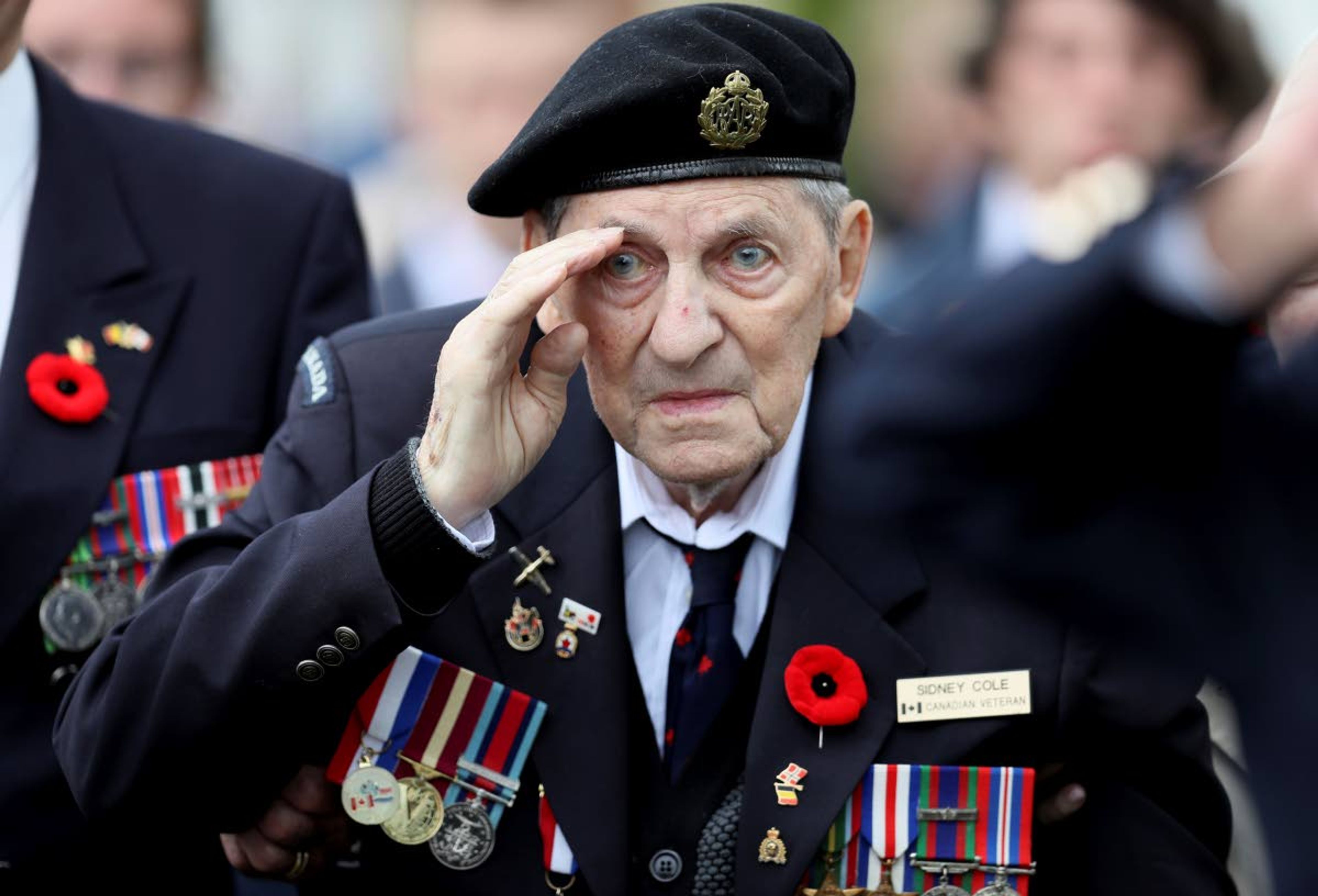 Canadian World War II veteran Sidney Cole salutes as he attends a ceremony at the Beny-sur-Mer Canadian War Cemetery in Reviers, Normandy, France, Wednesday, June 5, 2019. A ceremony was held on Wednesday for Canadians who fought and died on the beaches and in the bitter bridgehead battles of Normandy during World War II. (AP Photo/David Vincent)