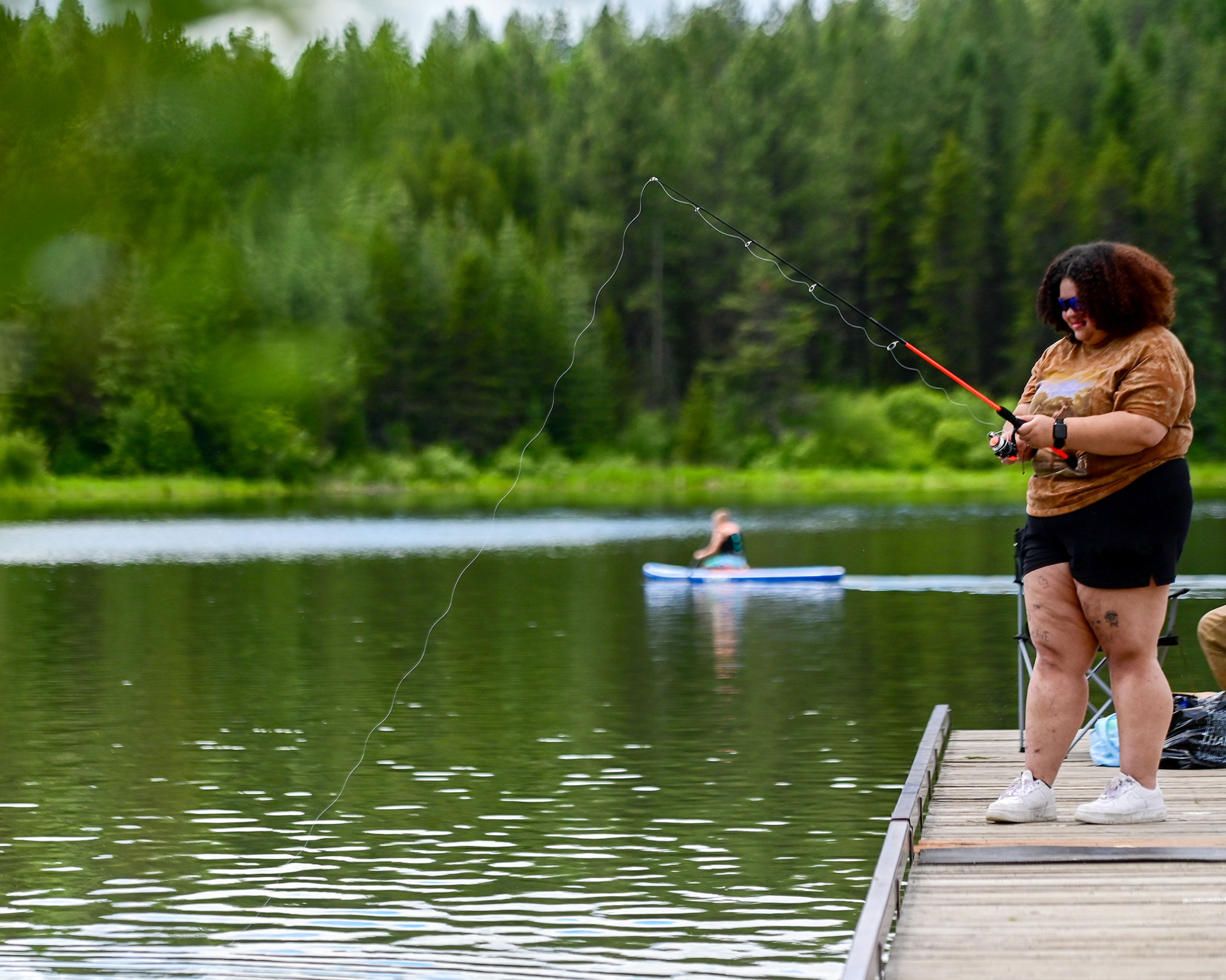 Deanna Whitley, a recent Washington State University alum, fishes off the edge of a pier at the Spring Valley Reservoir outside of Troy on Friday.