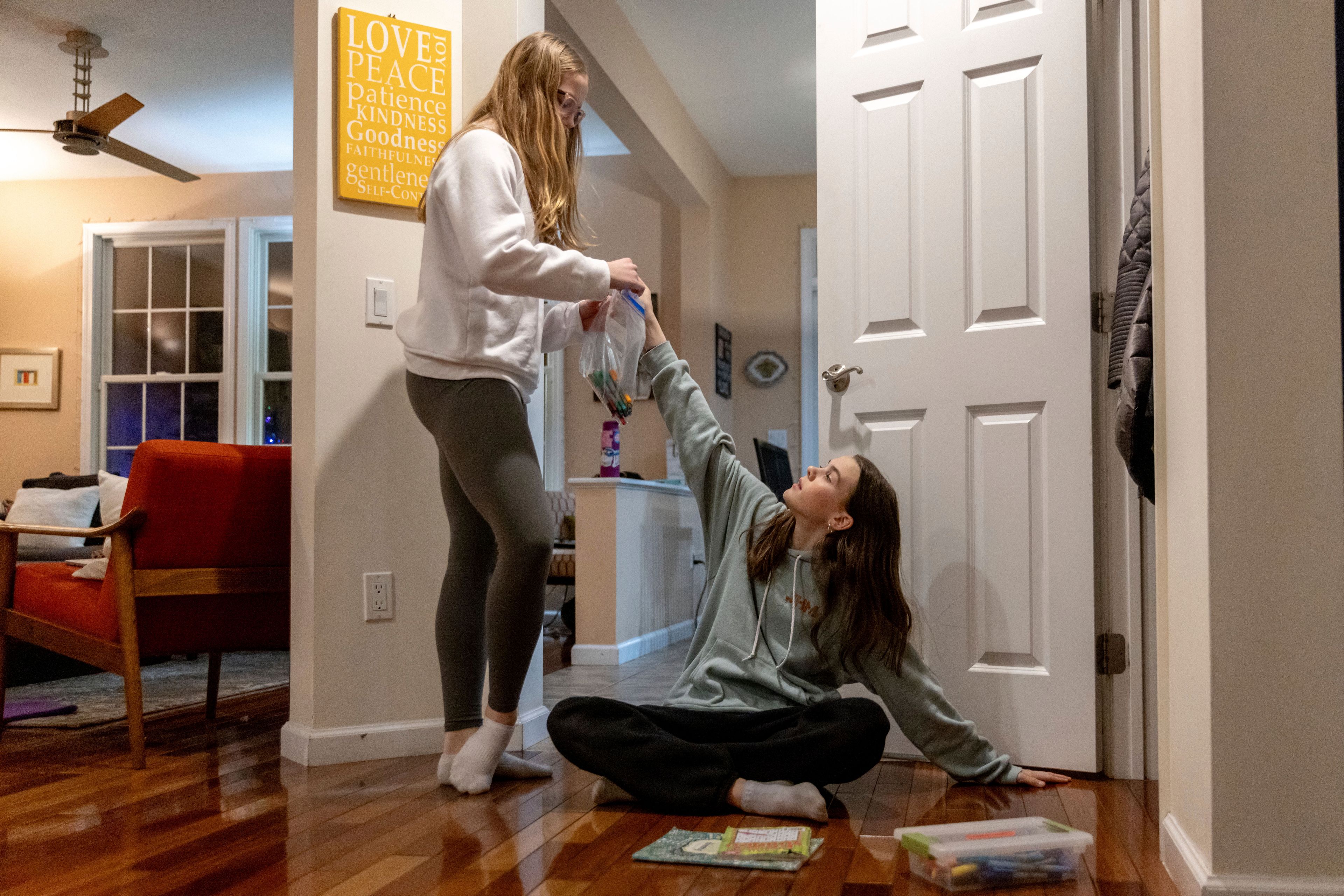 Kate and Sutton Bulkeley pack art materials ahead of a ski vacation, Friday, Feb. 16, 2024, in Westport, Conn. No longer just a distraction or a way to connect with friends, social media has matured into a physical space and a community that almost all U.S. teenagers belong to. Up to 95% of teenagers say they use social media, with more than one-third saying they are on it “almost constantly,” according to the Pew Research Center.