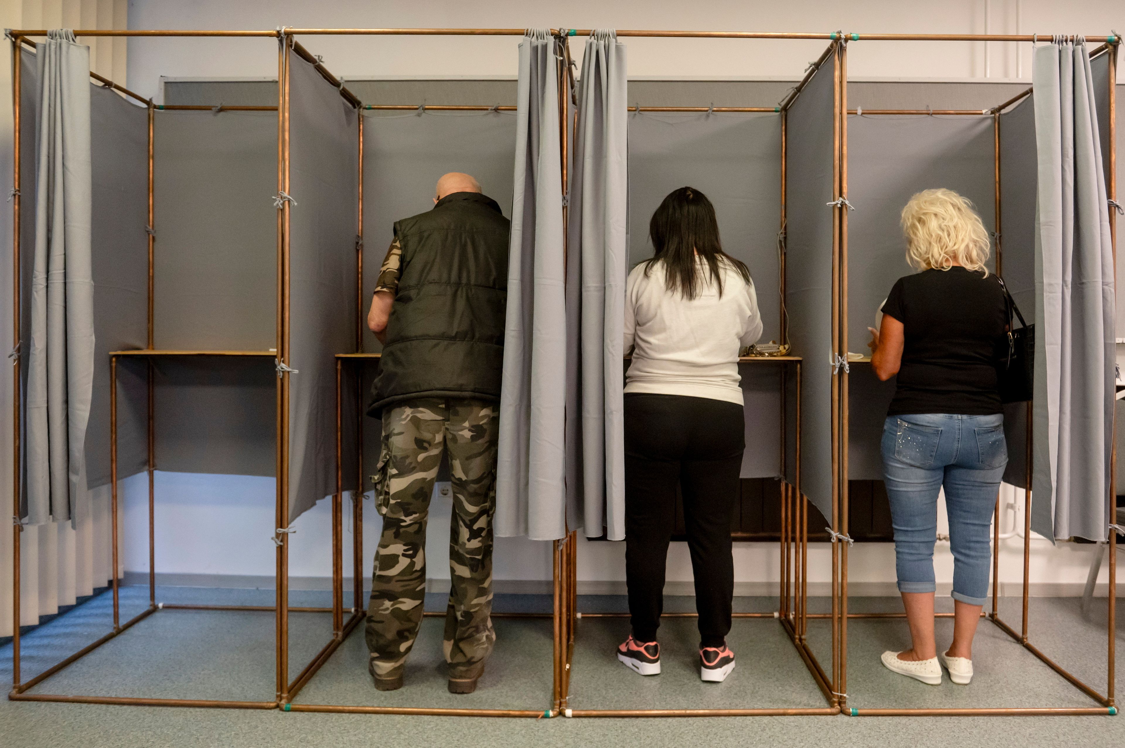 Voters fill in their ballot papers at a polling station during the European Parliament and the local elections in Salgotarjan, Hungary, Sunday, June 9, 2024.