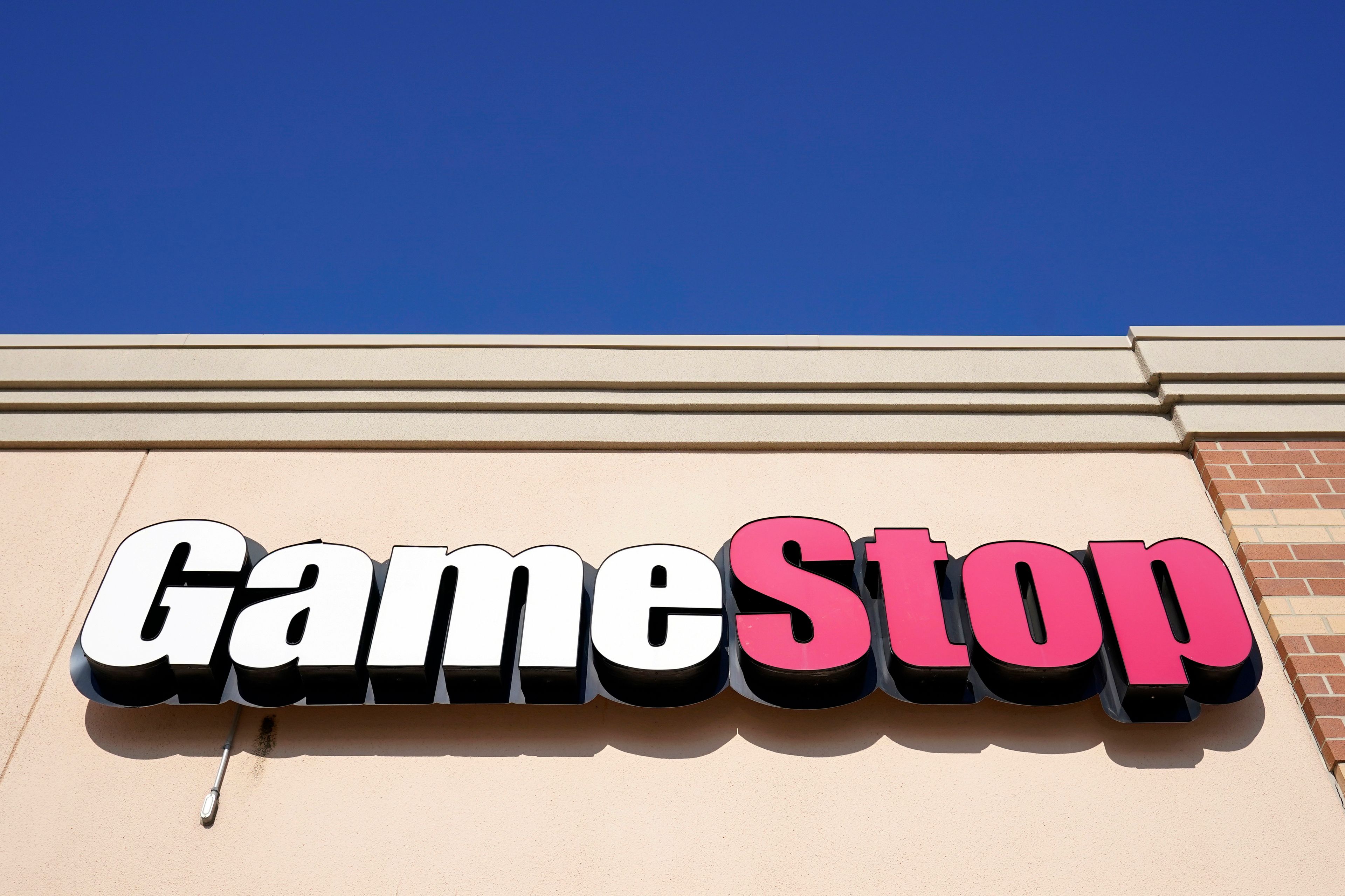 FILE - A GameStop sign is displayed above a store in Urbandale, Iowa, on Jan. 28, 2021. GameStop managed to narrow its losses in the first quarter, but the video game retailer's revenue fell as sales weakened for hardware and accessories, software and collectibles. The results were released shortly after the man at the center of the pandemic meme stock craze, who is known as “Roaring Kitty” on social media platforms YouTube and X, disclosed that he'll be hosting a YouTube livestream on Friday June 7, 2024.