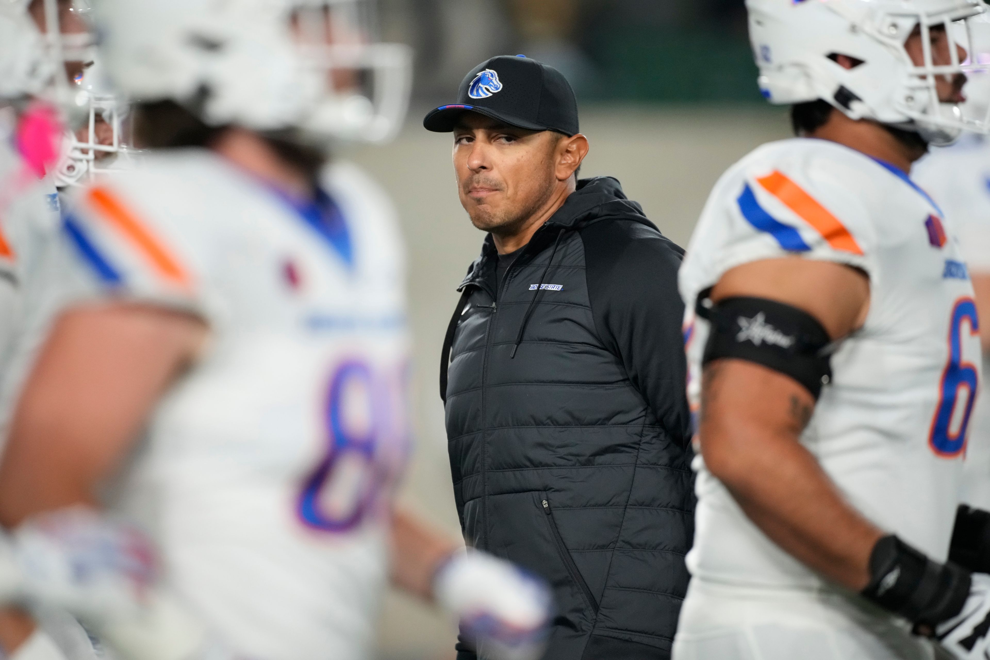 Boise State head coach Andy Avalos looks on as players warm up before an NCAA college football game against Colorado State on Saturday, Oct. 14, 2023, in Fort Collins, Colo. (AP Photo/David Zalubowski)