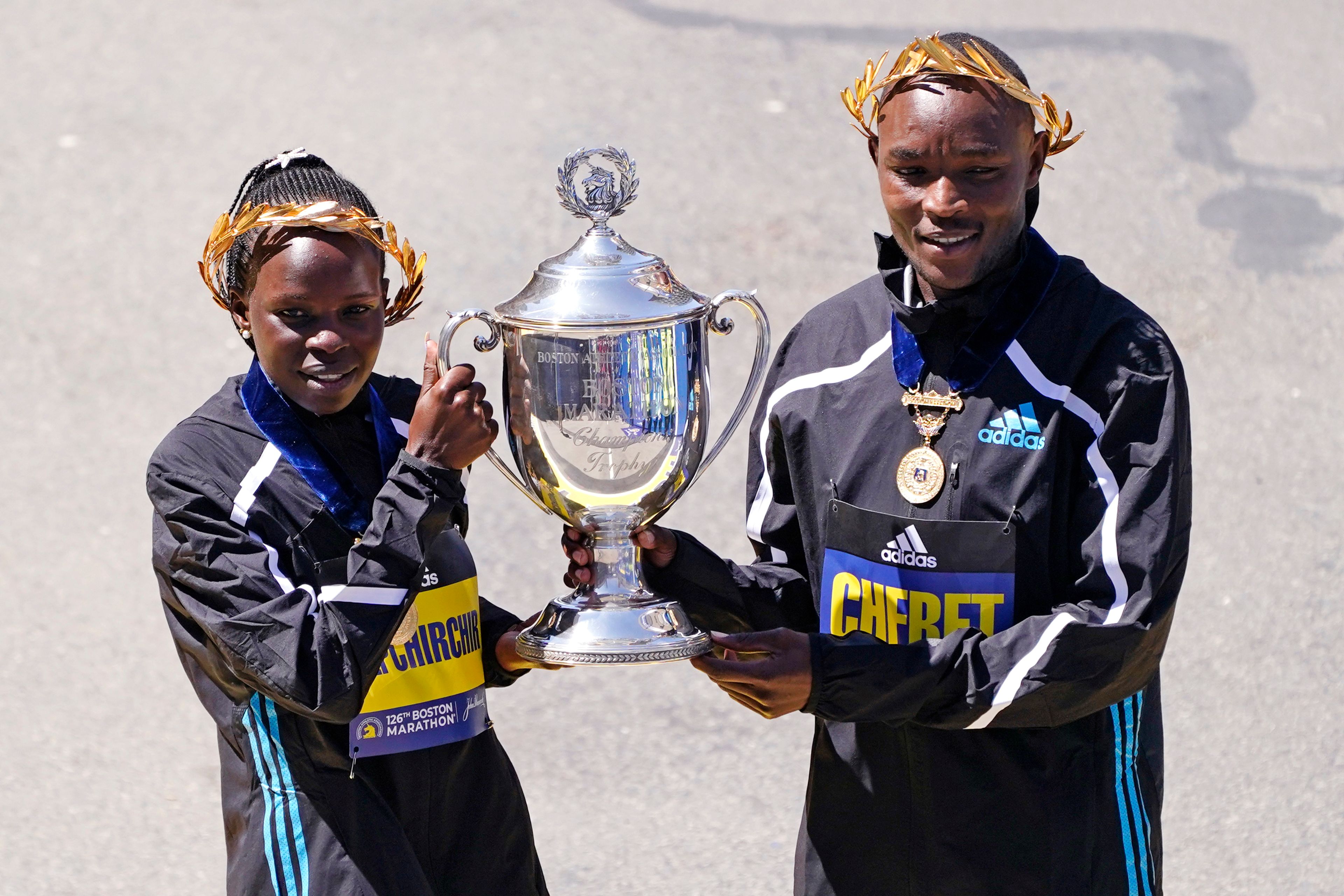 Boston Marathon women's division winner Peres Jepchirchir, of Kenya, left, and men's winner Evans Chebet, of Kenya, pose at the finish line Monday, April 18, 2022, in Boston. (AP Photo/Charles Krupa)