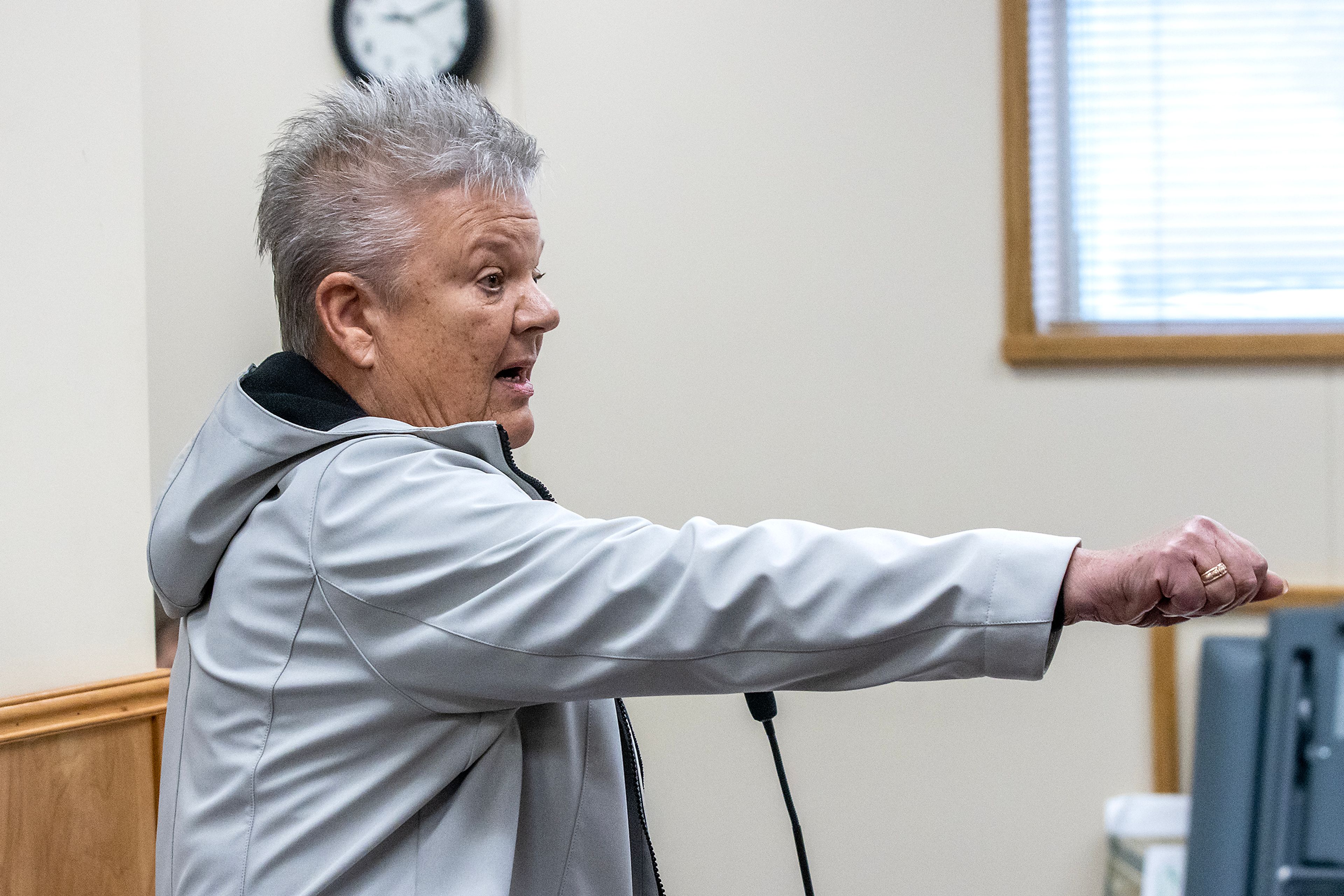 Connie Morrow holds out her hand to symbolize giving the commissioners the keys the the Asotin County Family Aquatics Center and saying “your run it,” at the commissioners meeting Monday morning in Asotin.