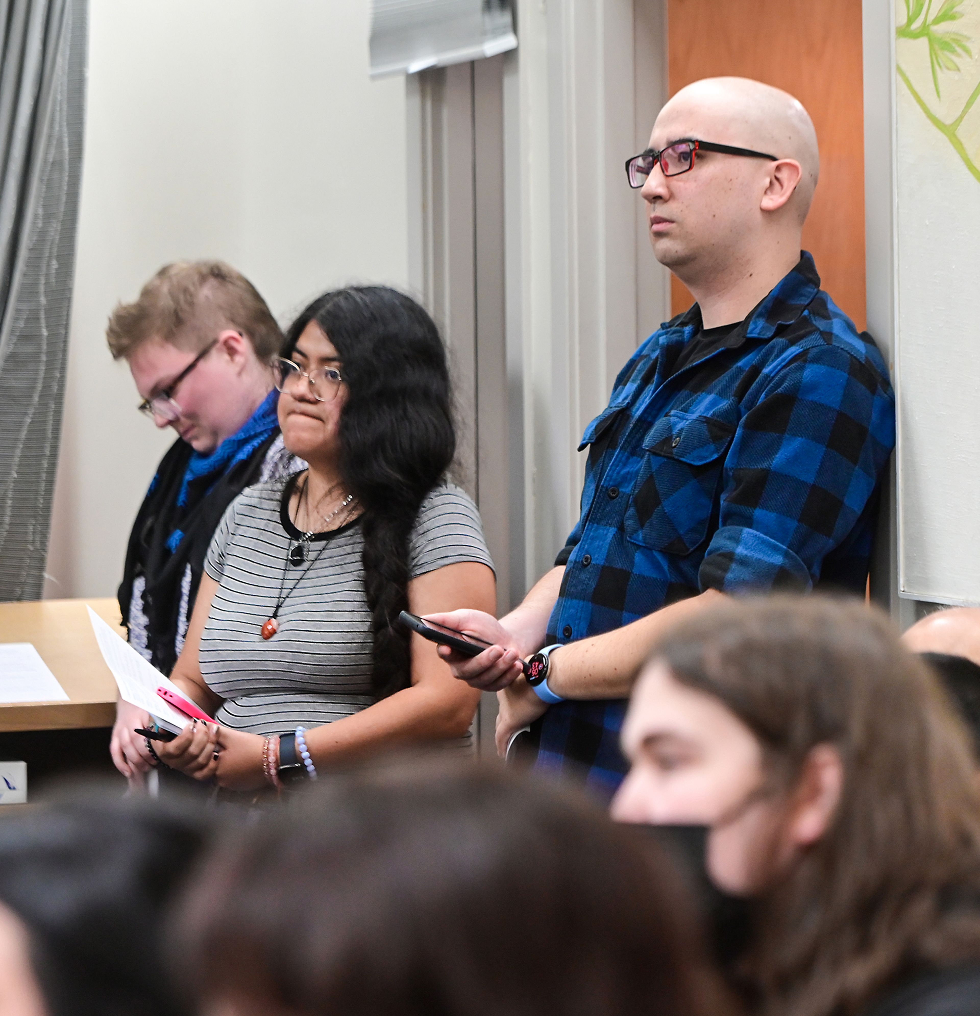 Pullman City Council members Carla De Lira and Eric Fejeran, right, listen to community members give their input on a drafted ceasefire resolution for Gaza and Israel on Monday at the Neill Public Library in Pullman.