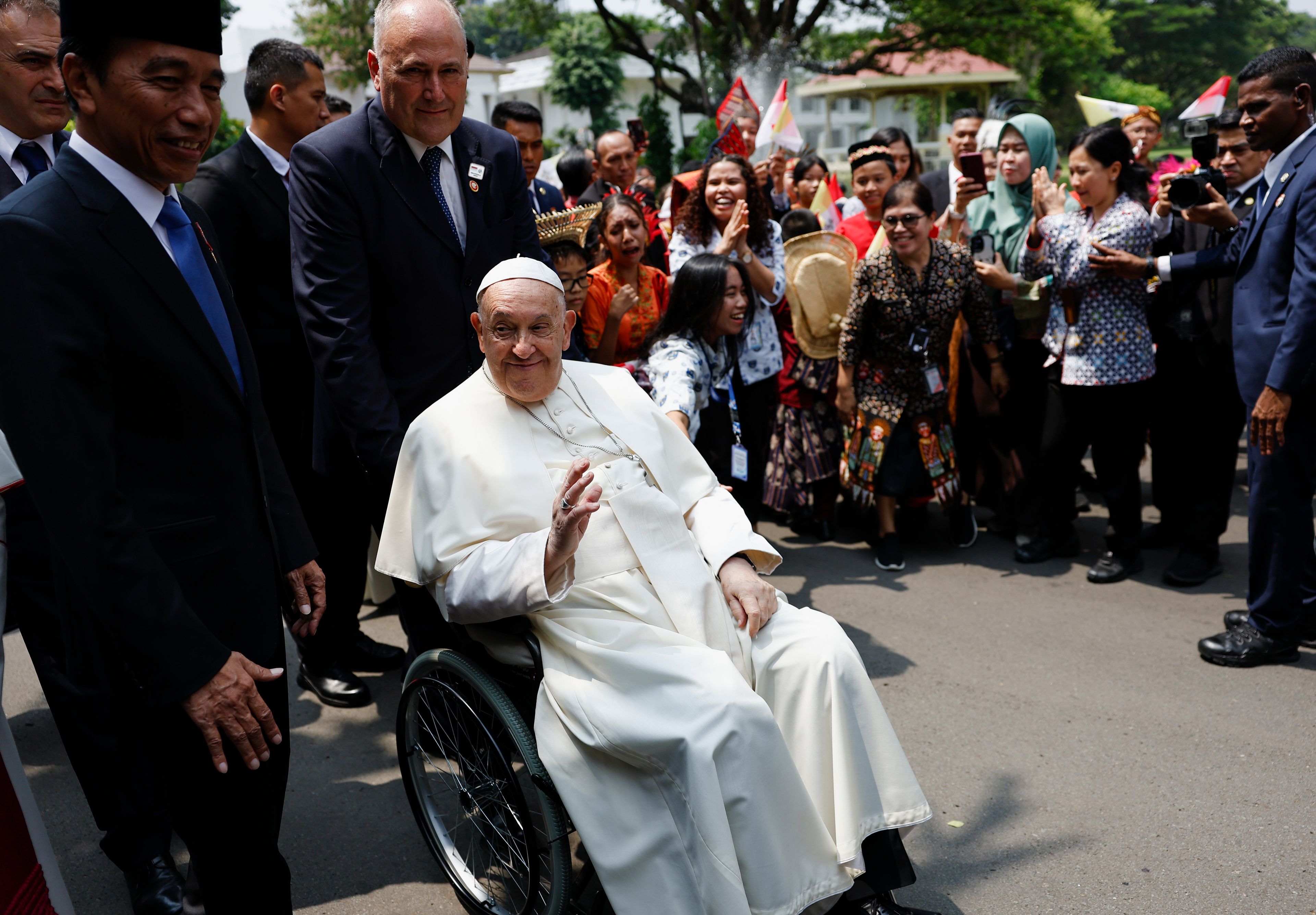 Pope Francis, foreground right, and Indonesian President Joko Widodo, left, meet people after attending a meeting with Indonesian authorities, civil society and the diplomatic corps, during his apostolic visit to Asia, at the Presidential Palace in Jakarta Wednesday, Sept. 4, 2024.