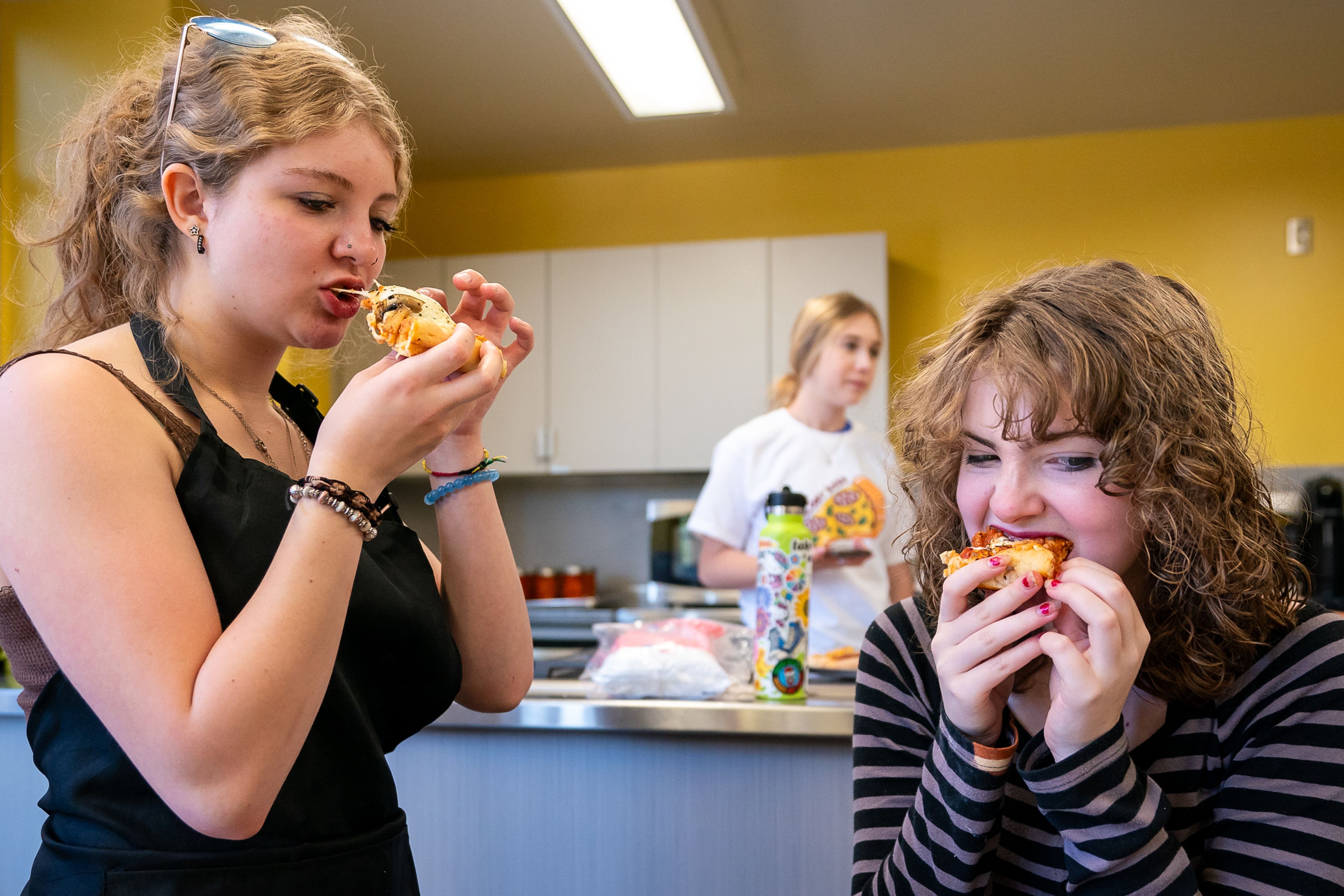 Kyle Darg, left, 16, and Xai Carey, 15, both of Wallace, take a bite of their finished margarita pizza with mushrooms during the final day of the 2023 Pizza-ology Camp on Wednesday at the Carmelita Spencer Food Laboratory in Moscow.