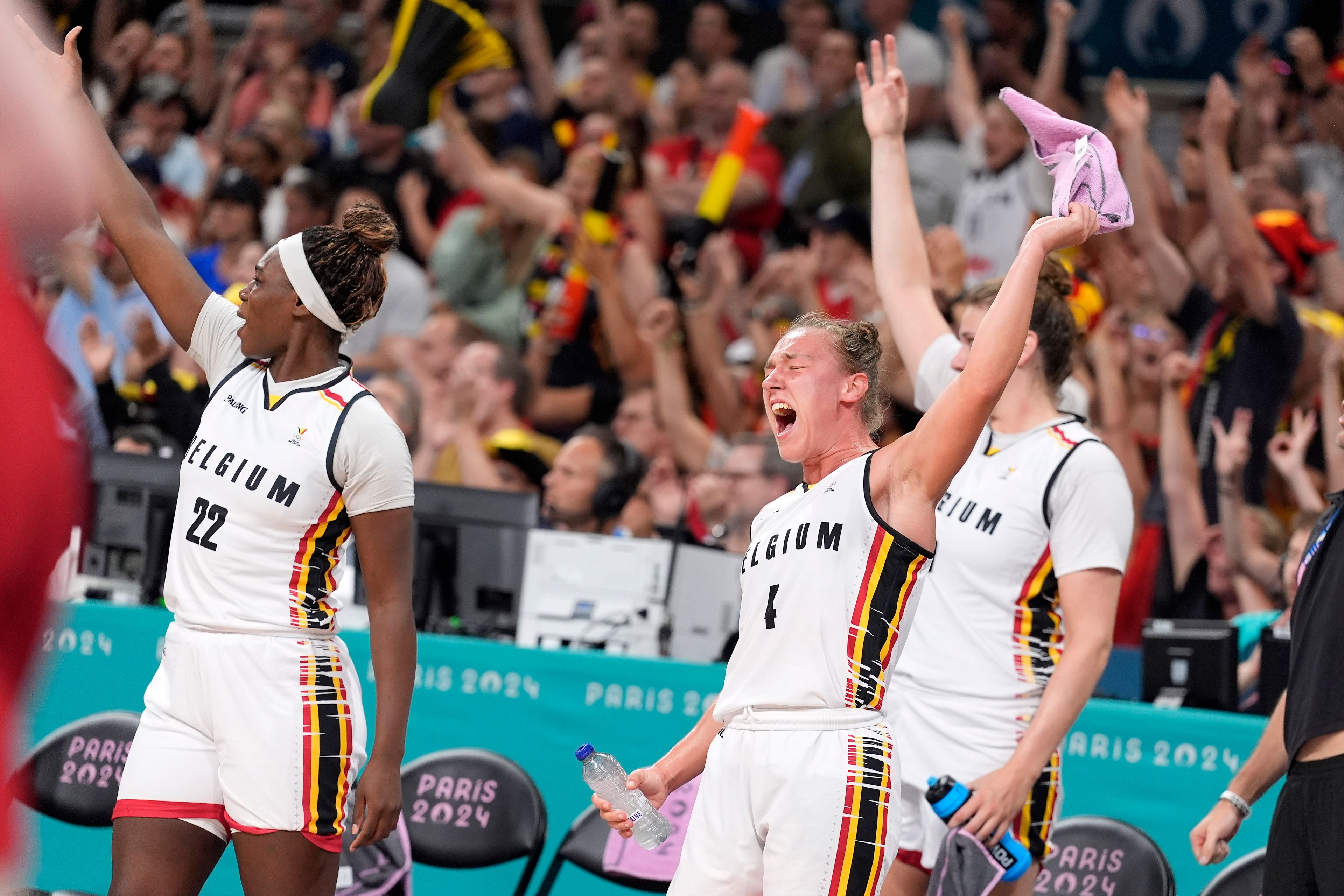 Belgium's Elisa Ramette, center, celebrates with teammates from the bench after they scored during a women's basketball game against the United States at the 2024 Summer Olympics, Thursday, Aug. 1, 2024, in Villeneuve-d'Ascq, France. (AP Photo/Michael Conroy)