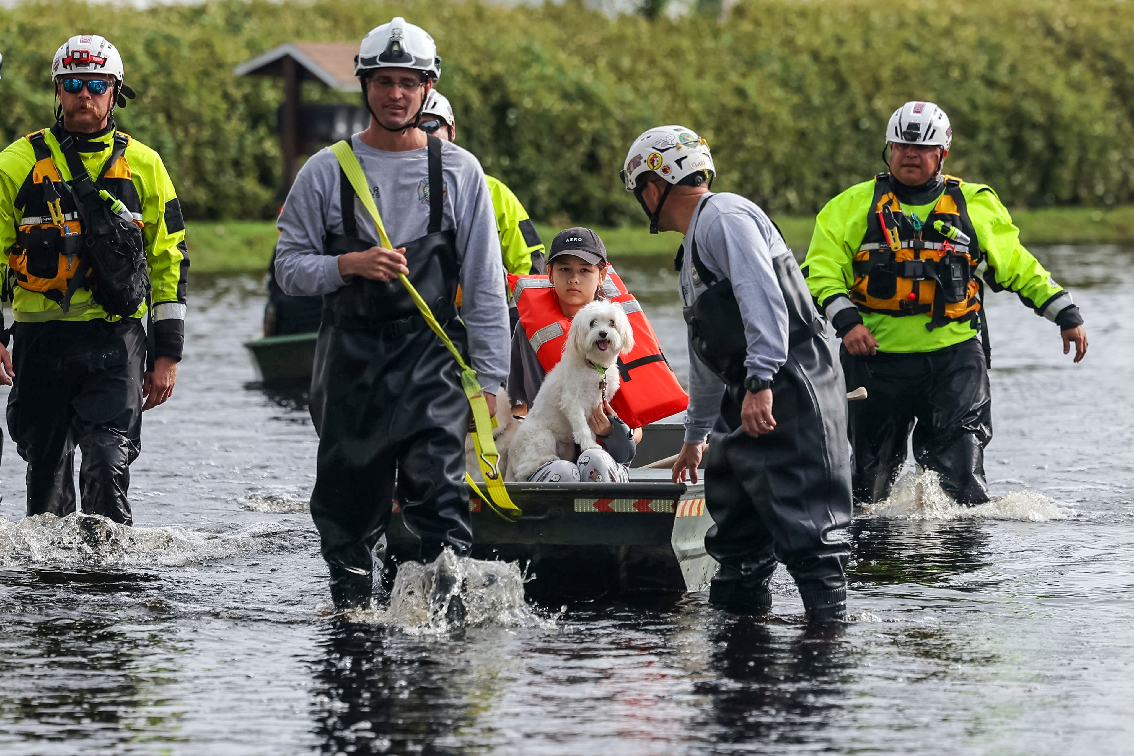 Amy Bishop is evacuated from her home by Pasco County Fire and Rescue and Sheriff's Office teams as waters rise in her neighborhood after Hurricane Milton caused the Anclote River to flood, Friday, Oct. 11, 2024, in New Port Richey, Fla. (AP Photo/Mike Carlson)