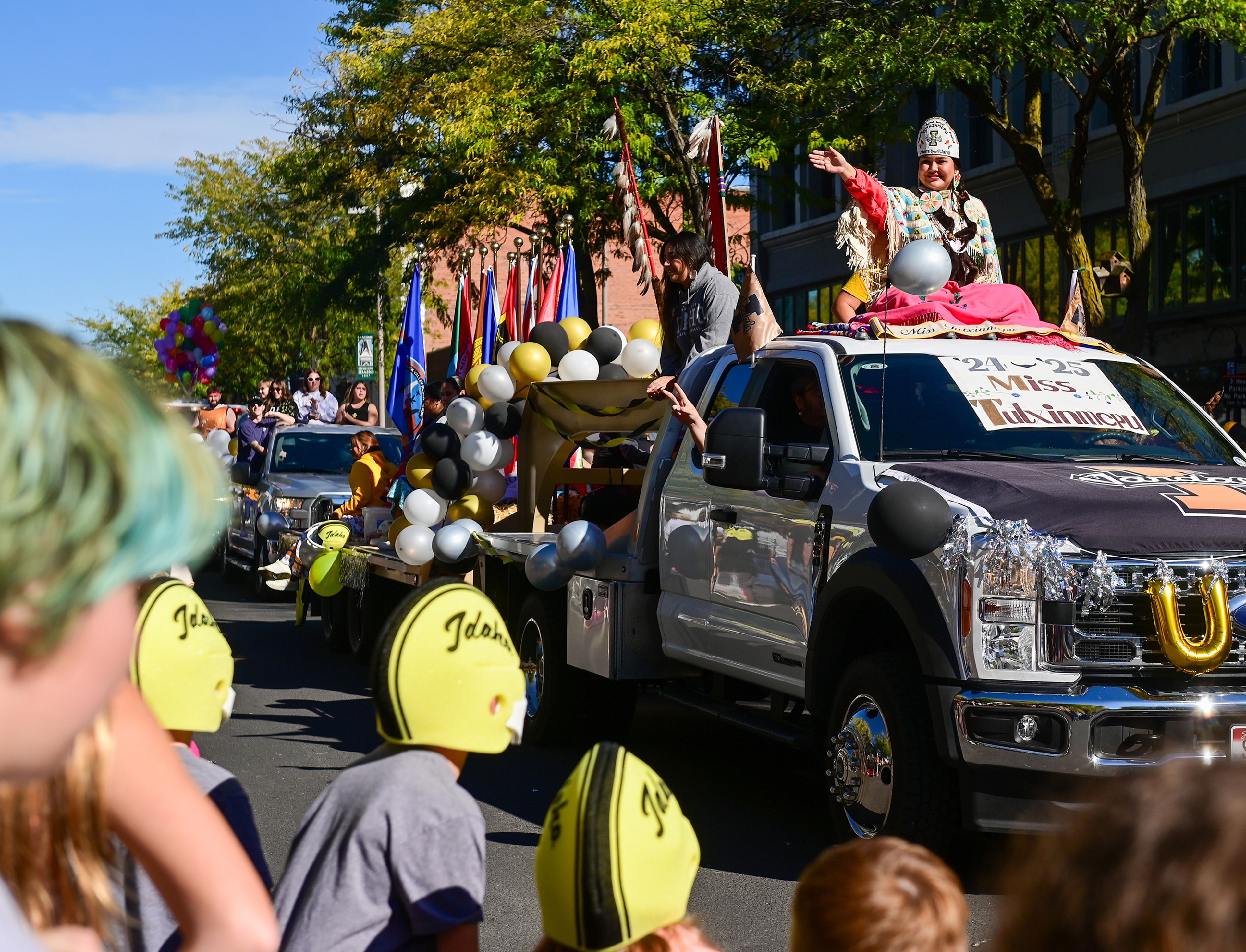 Miss Tutxinmepu waves from the University of Idaho Native American Student Center float in the homecoming parade Saturday in Moscow.