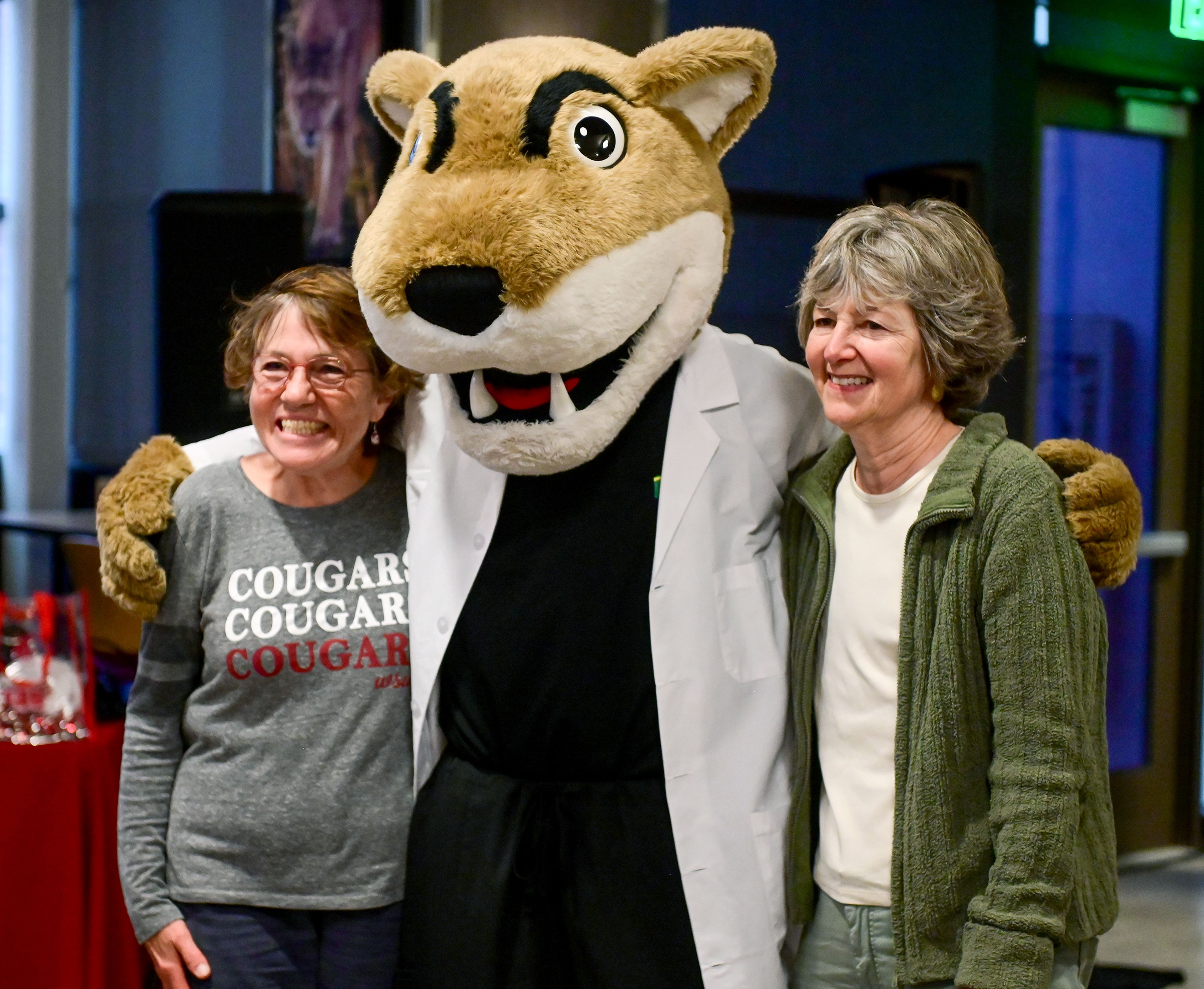 Washington State University College of Veterinary Medicine alumni from the class of 1980 Adawna Windom, left, and Lisa Kramerpose pose with WSU mascot Butch T. Cougar at a 125th anniversary celebration for the college Friday in Pullman.