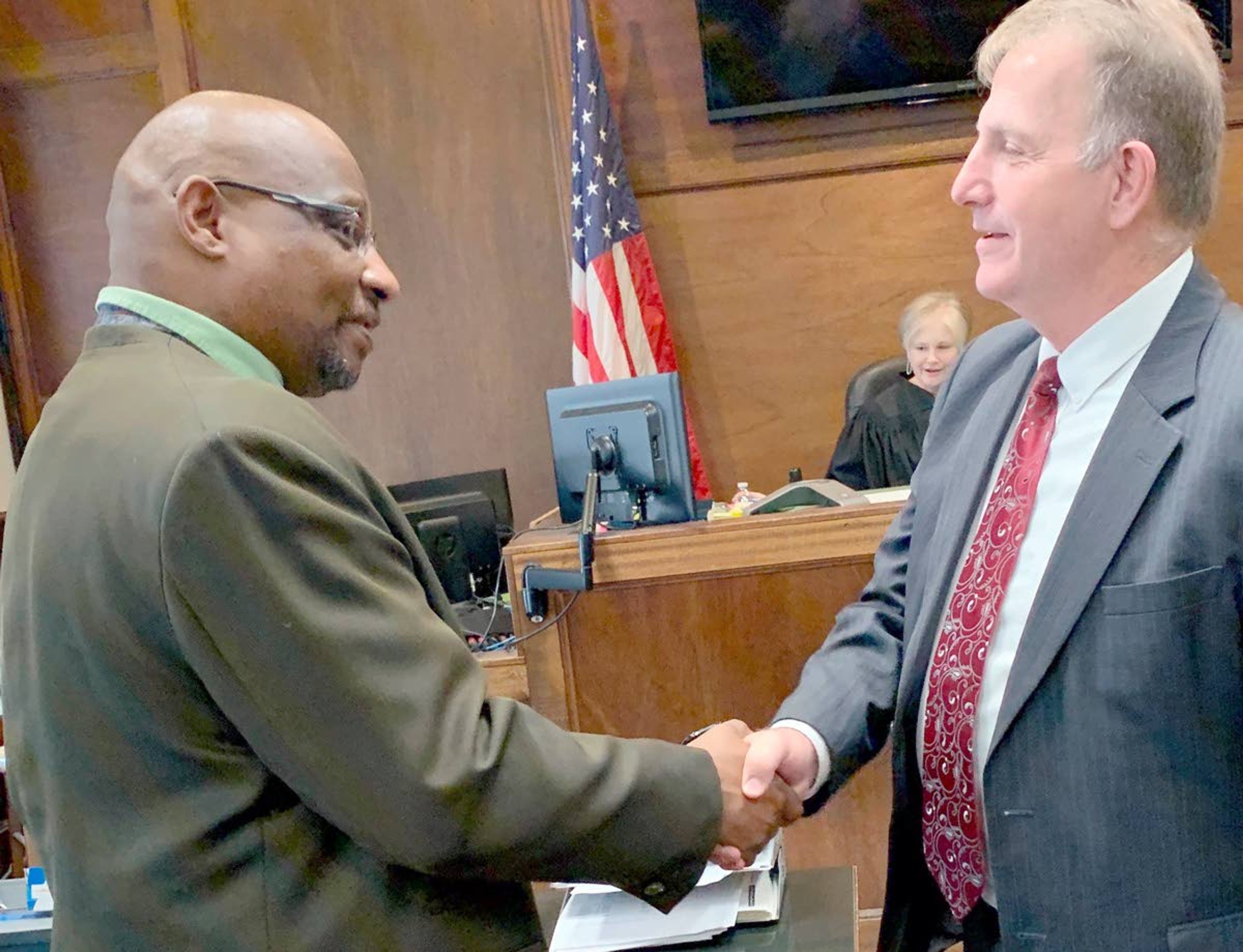 Walmart employee Mark Domino (left) and Clarkston attorney Todd Richardson shake hands after a resolution was reached between the two parties Thursday morning in Asotin County District Court. Charges of resisting arrest and obstructing a law enforcement officer will be dismissed Feb. 4, if Domino remains crime-free.