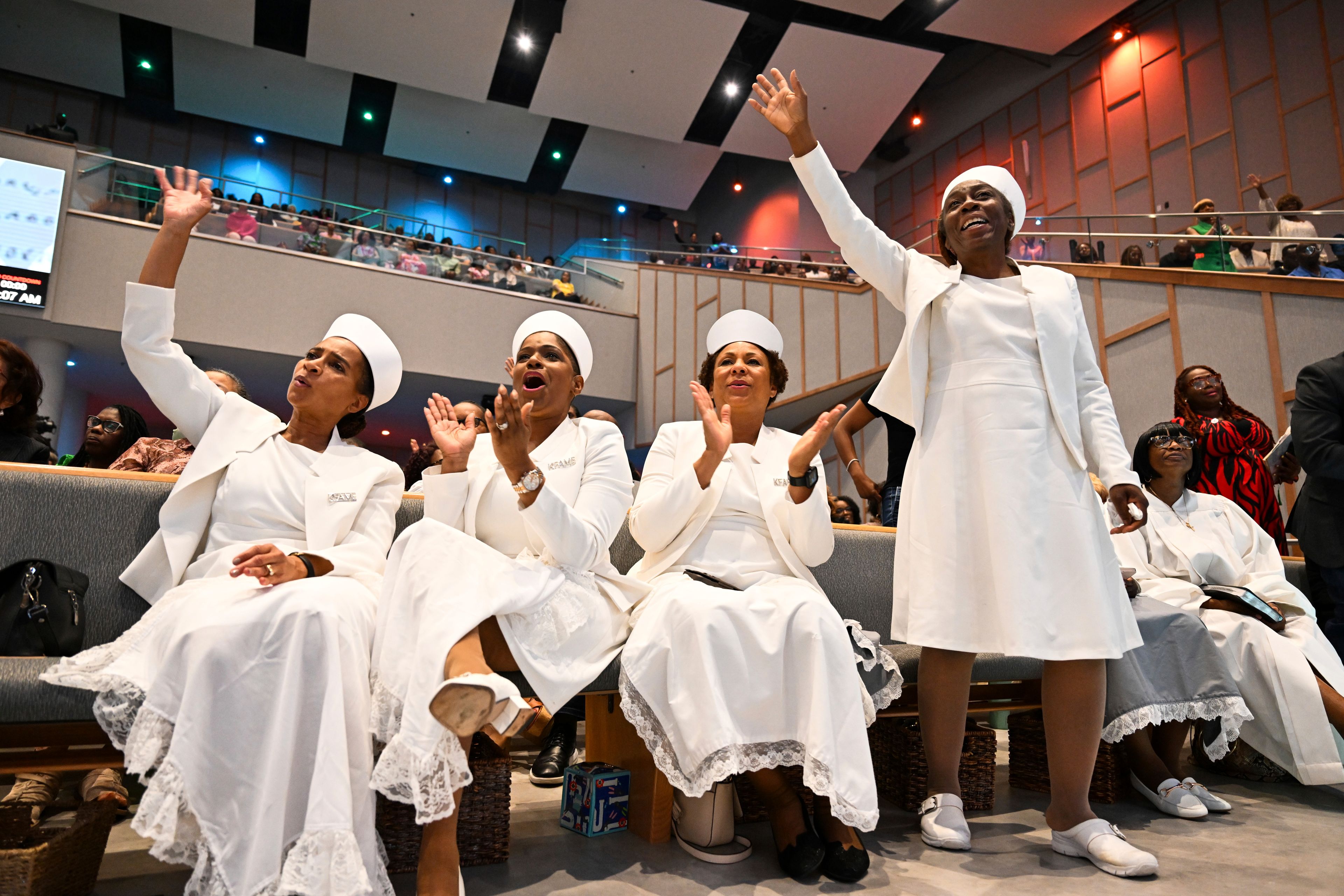 Members of the congregation at Kingdom Fellowship AME Church raise their hands in praise during church service, Sunday, June 2, 2024, in Calverton, Md. The suburban Maryland congregation, led by the Rev. Matthew L. Watley, has landed at the top of a list of the fastest-growing churches in America.