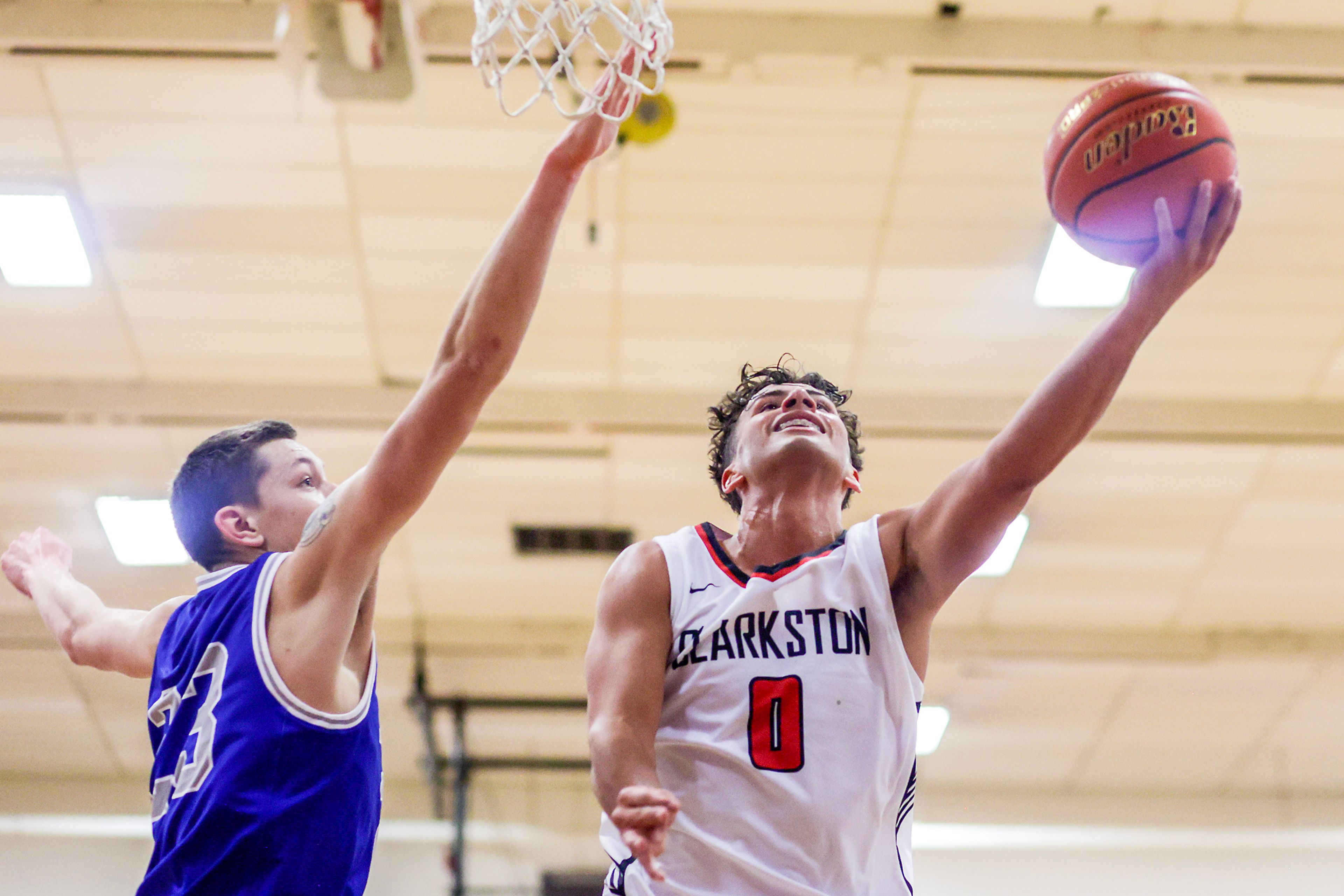 Clarkston guard Xavier Santana, right, shoots a layup as Pullman small forward Dane Sykes defends during Tuesday's Class 2A Greater Spokane League boys basketball game.