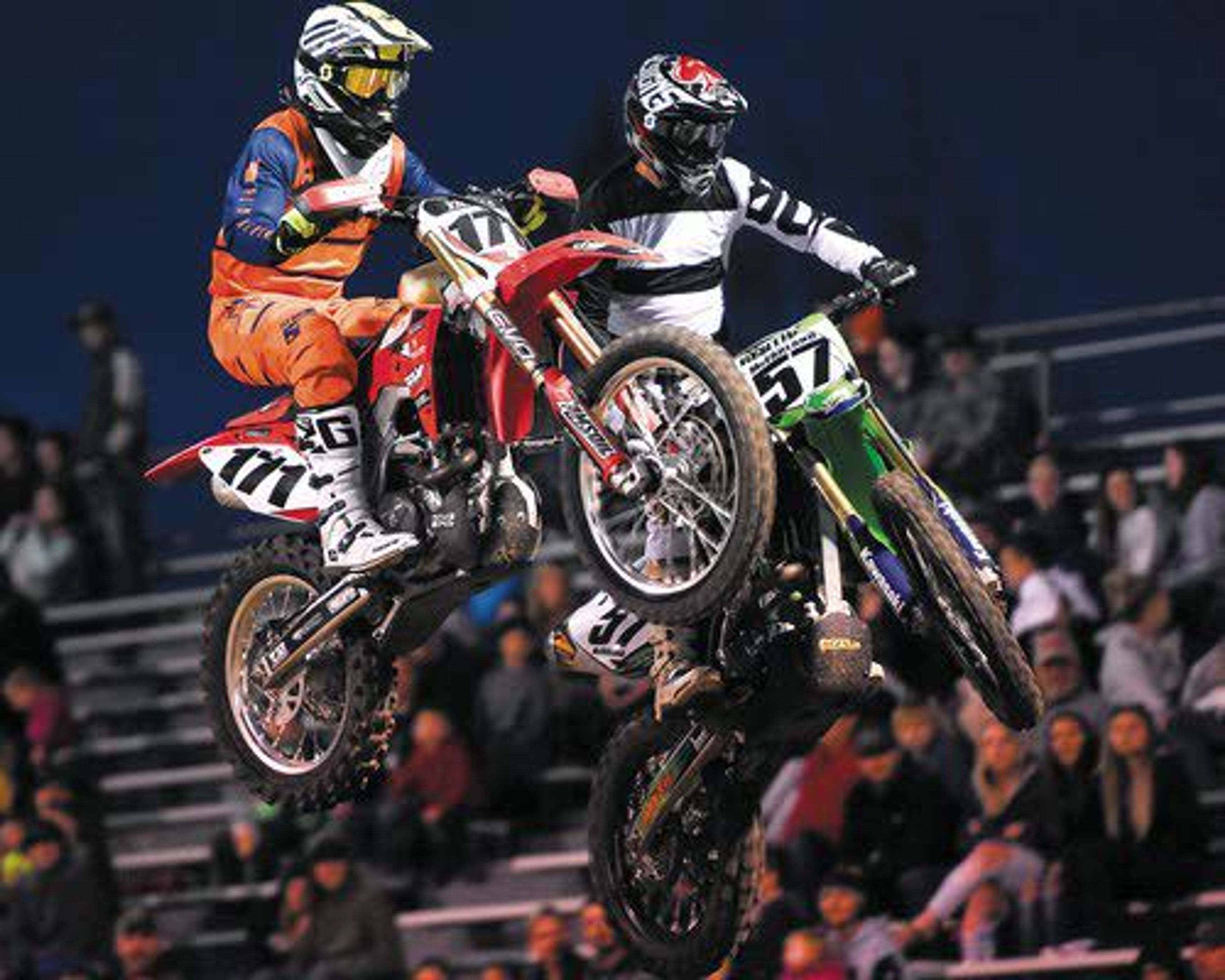 Dustin James, of Enterprise, Ore., left, and Jeremy McFarlane, right, of Lewiston, battle it out on the jumps during the 30+ veterans race on Saturday night at the Lewiston Supercross event at the Lewiston Roundup Grounds.