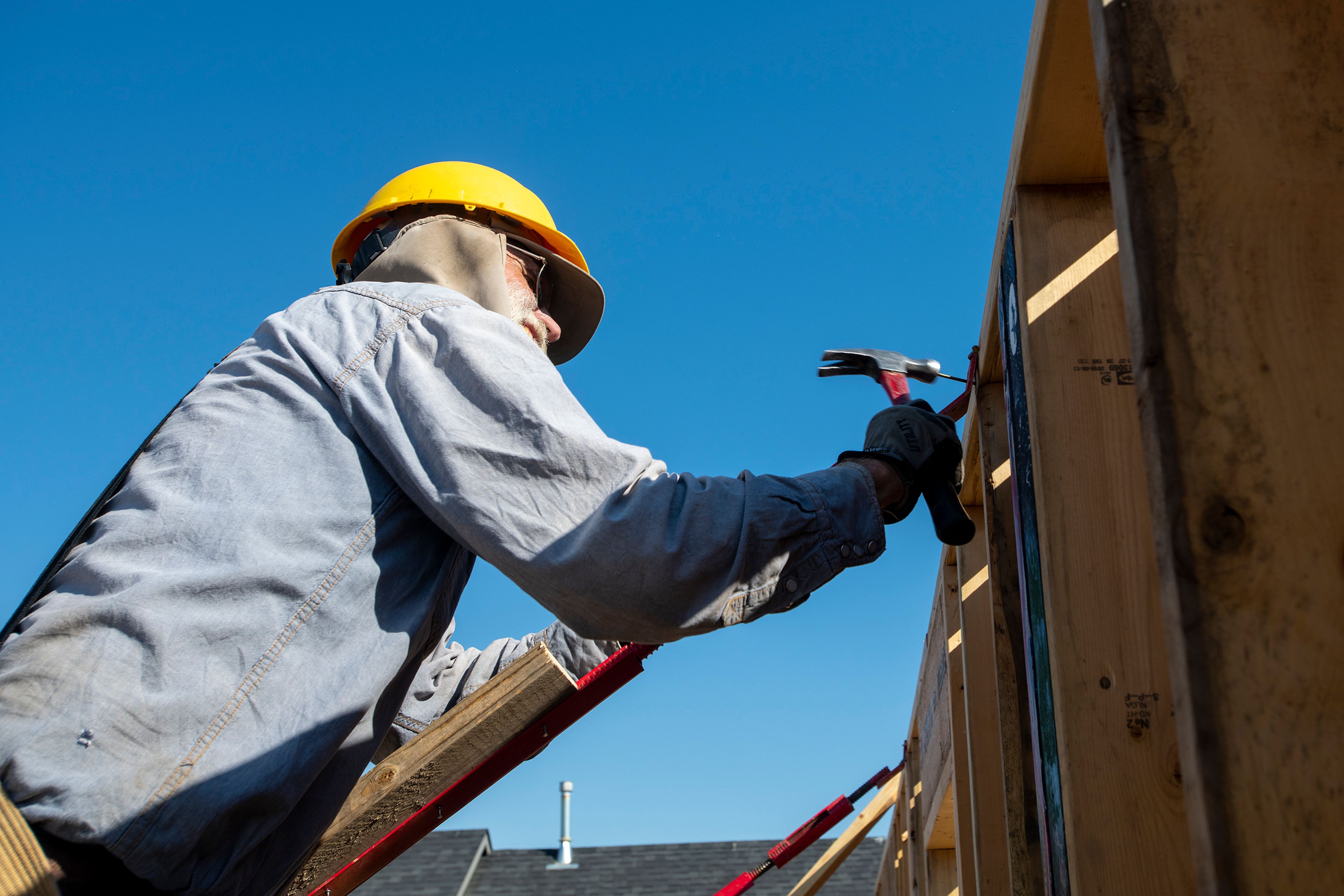 Volunteer Dan Hardesty hammers a nail into a wall of a home being constructed by volunteers of Palouse Habitat for Humanity on Leepike Court in Moscow.