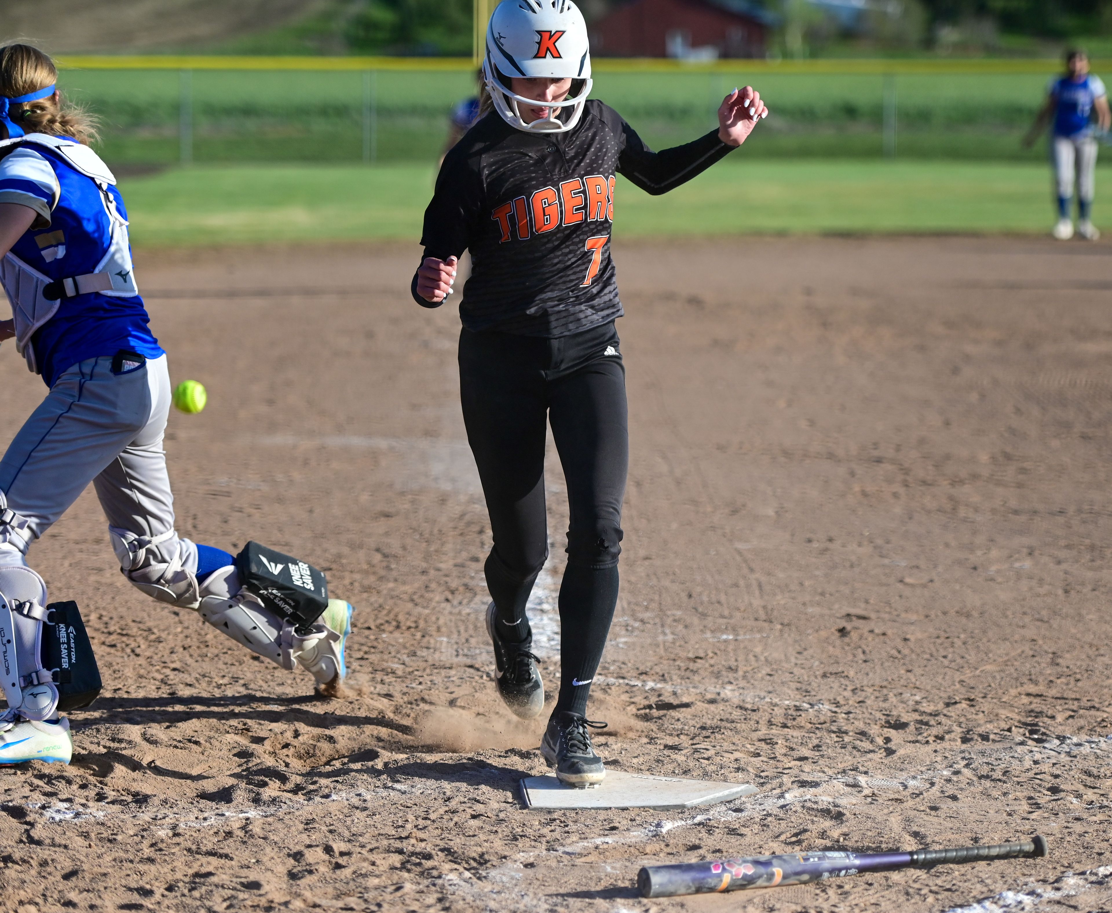 Kendrick’s Madelyn Proctor steps on home plate, scoring a run during an Idaho 2A district tournament championship game Wednesday in Genesee.