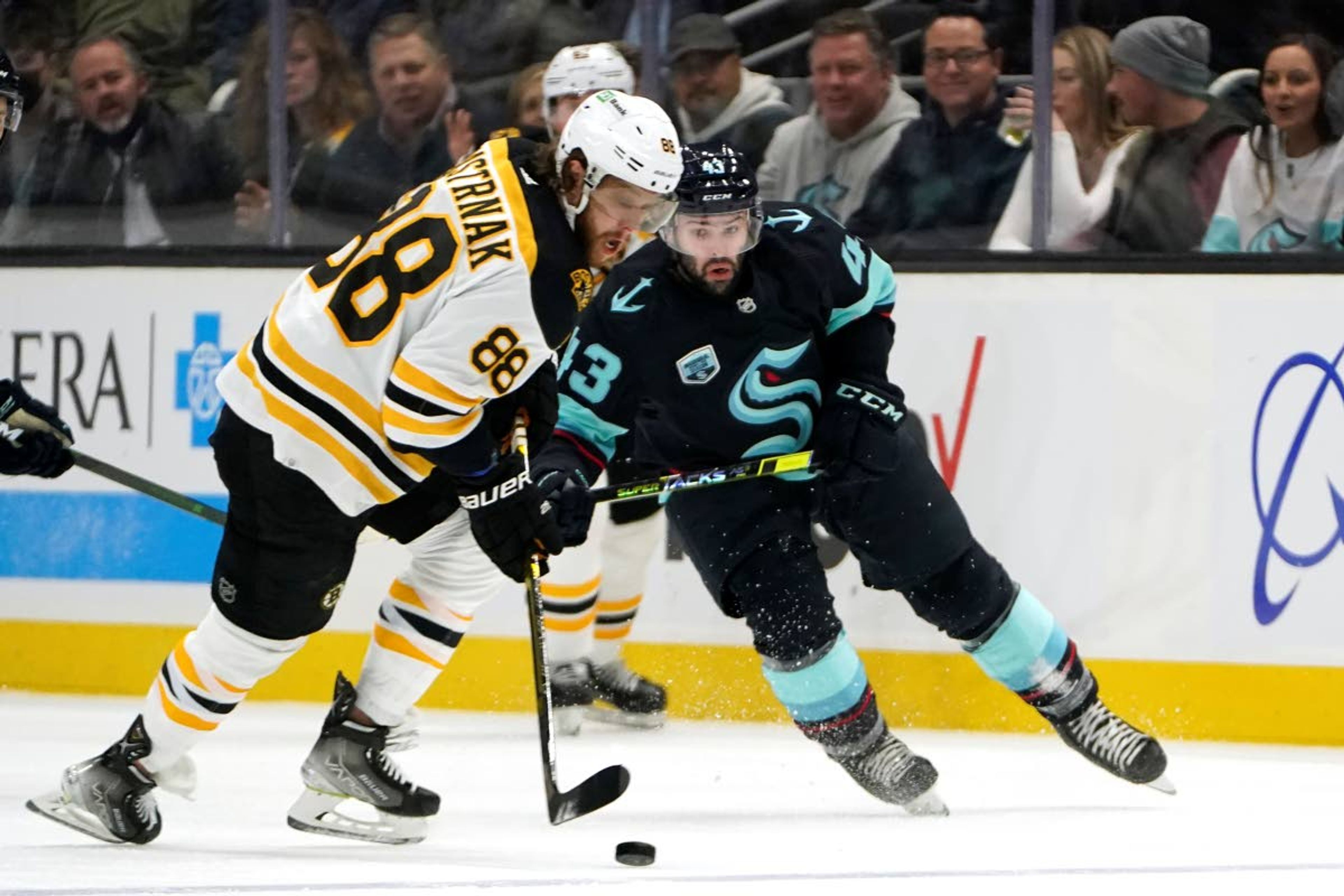 Boston Bruins' David Pastrnak (88) skates ahead of Seattle Kraken's Colin Blackwell (43) during the first period of an NHL hockey game Thursday, Feb. 24, 2022, in Seattle. (AP Photo/Elaine Thompson)