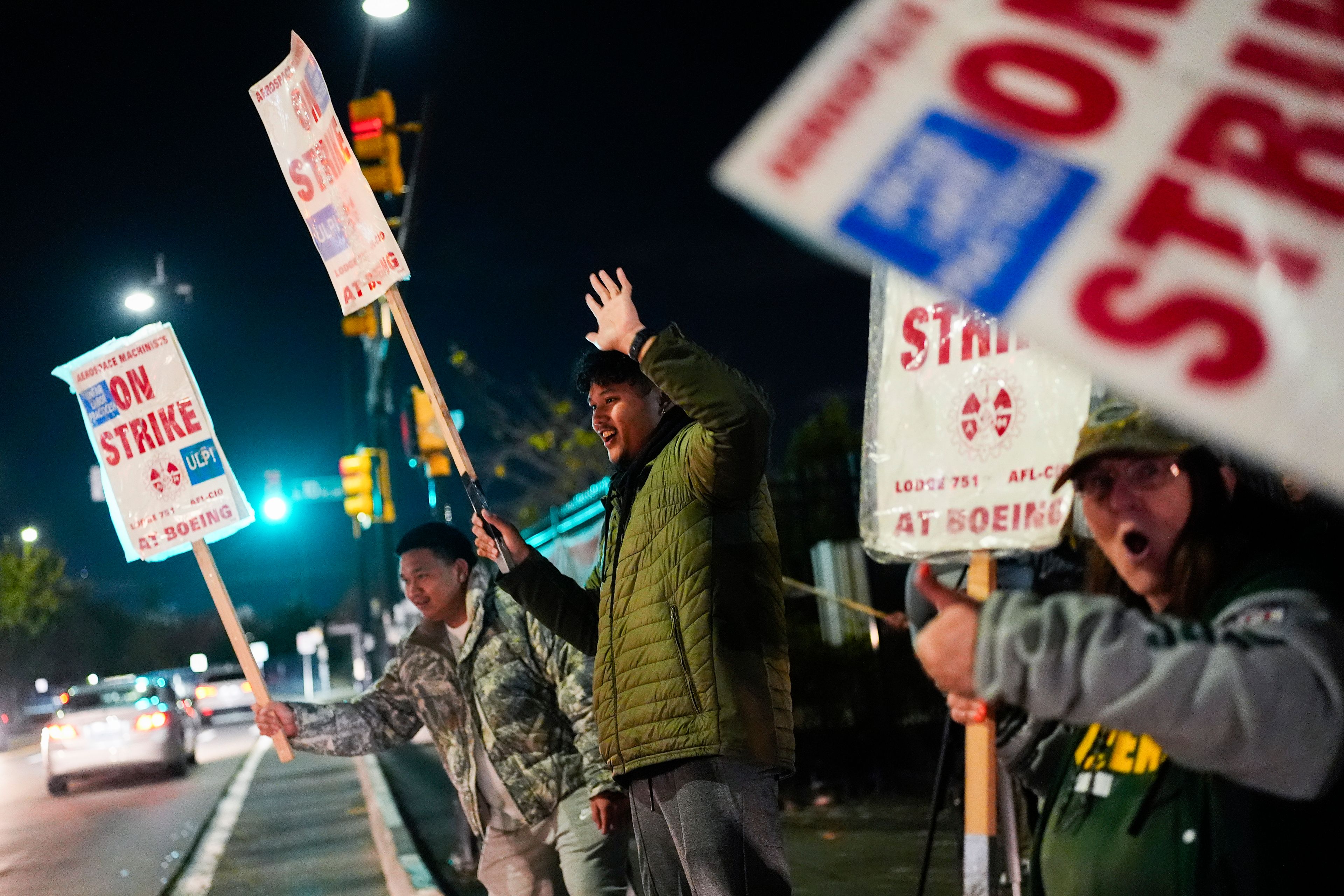 Boeing employees, including assembler Tyrone Hipolito, center, work the picket line after union members voted to reject a new contract offer from the company, Wednesday, Oct. 23, 2024, in Renton, Wash. (AP Photo/Lindsey Wasson)