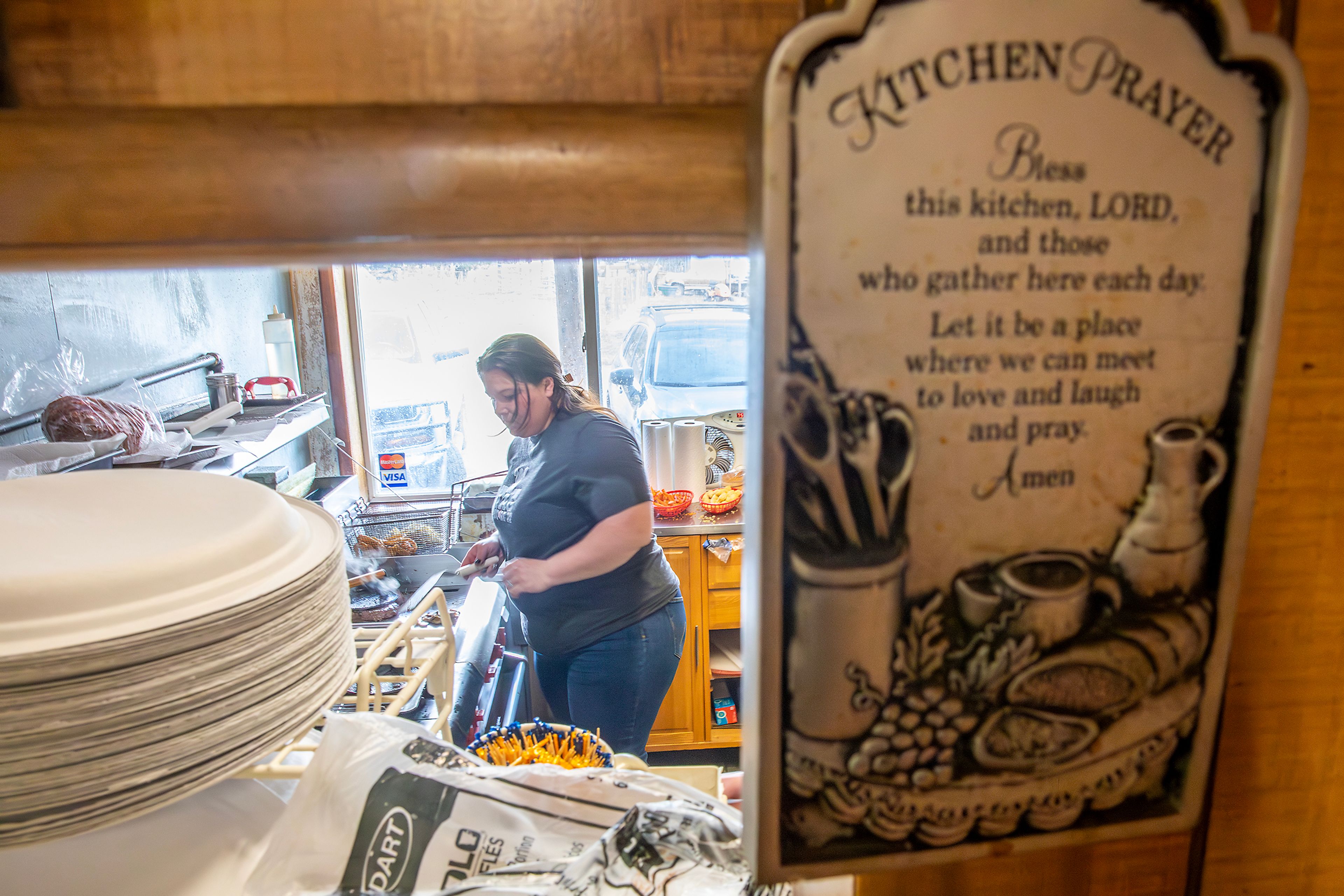 Brandee Ross, the new owner of the Keuterville Pub & Grub, prepares food Thursday during the lunch rush.