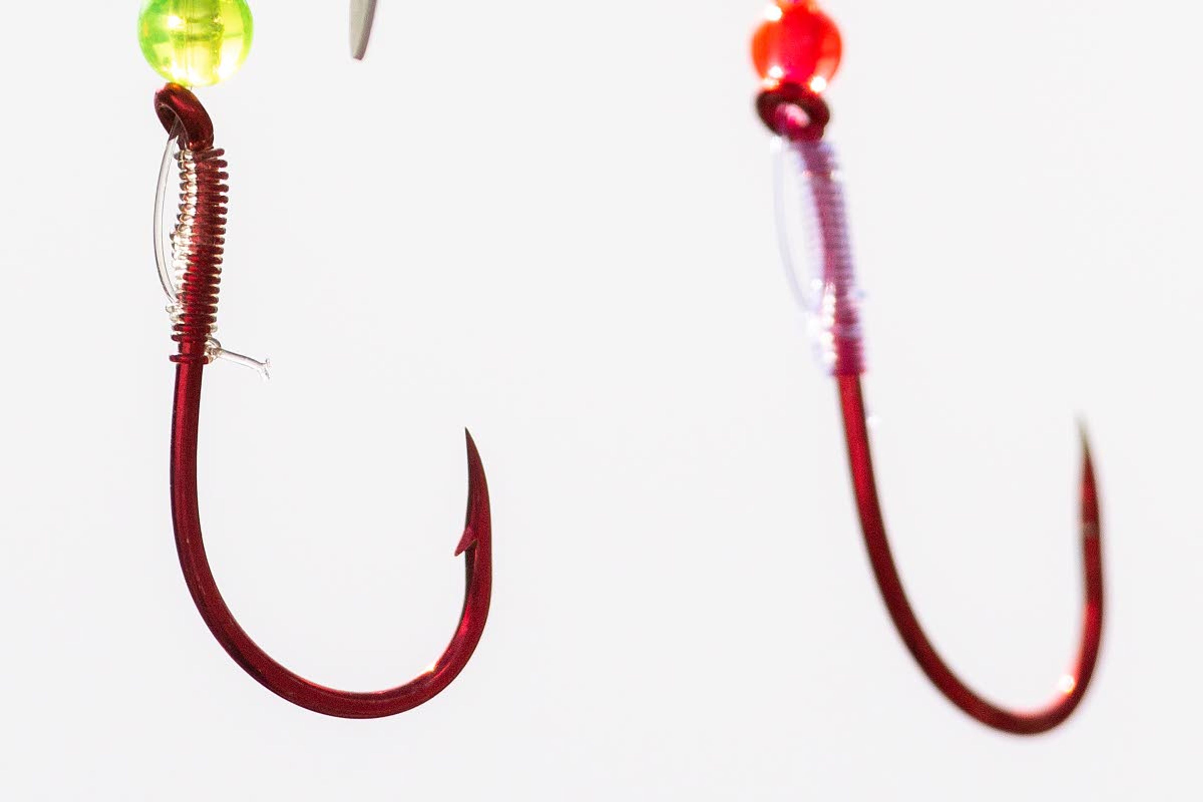 A barbed hook (on the left) versus a hook that has had its barb pinched down. Anglers fishing for salmon and steelhead have long been required to use barbless hooks, but that could be changing in some Washington rivers.