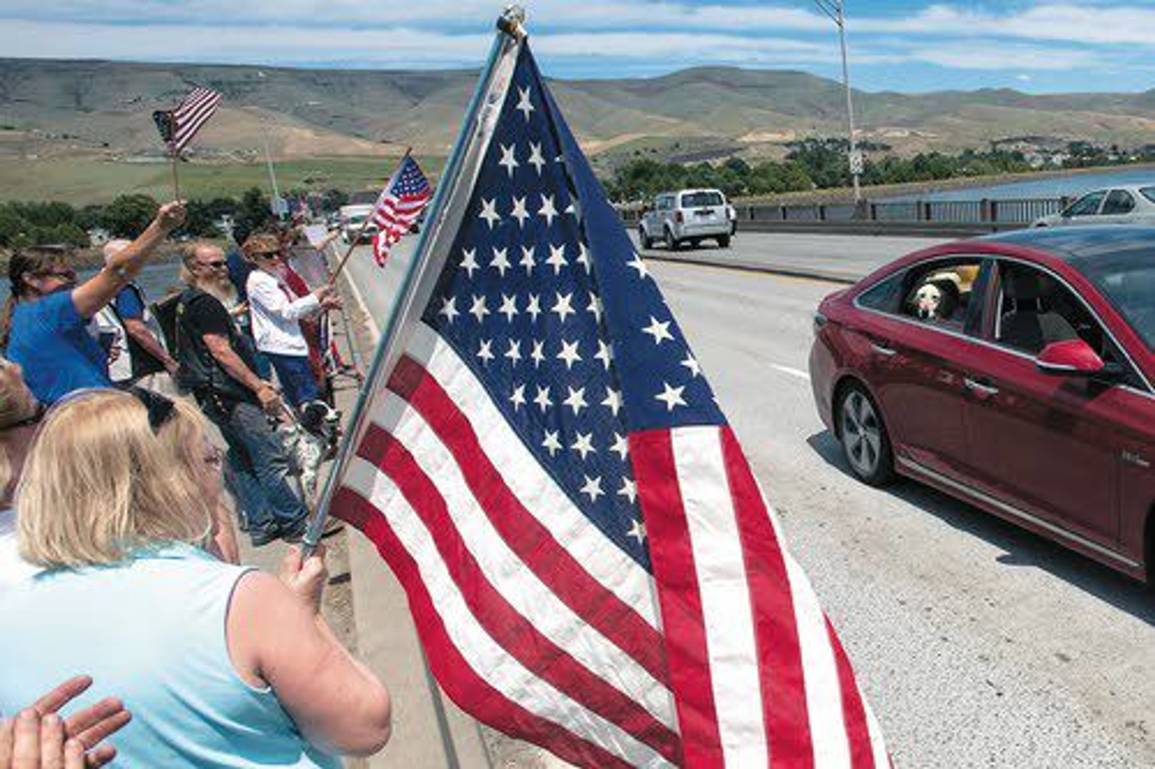 People lined up along Memorial Bridge Tuesday afternoon to welcome home U.S. Marine veteran Nick Montez and his dog, Mally. Montez and Mally worked together while serving in Afghanistan in 2012. Earlier this week, the two were reunited for good.