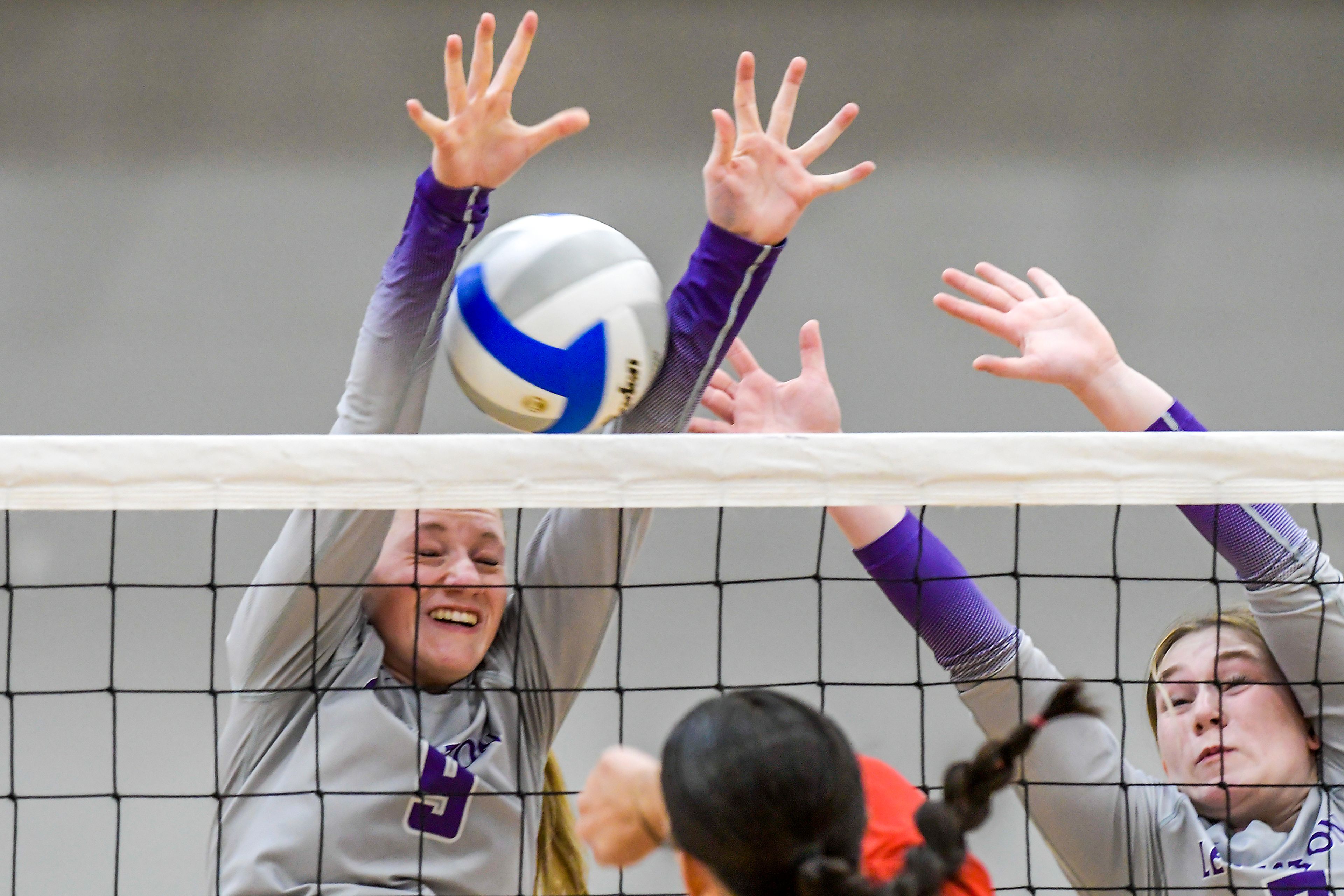 Lewiston middle blocker Elle Walker, 9, and outside hitter Avery Balmer look to block a Sandpoint spike during a volleyball game Thursday in Lewiston.,