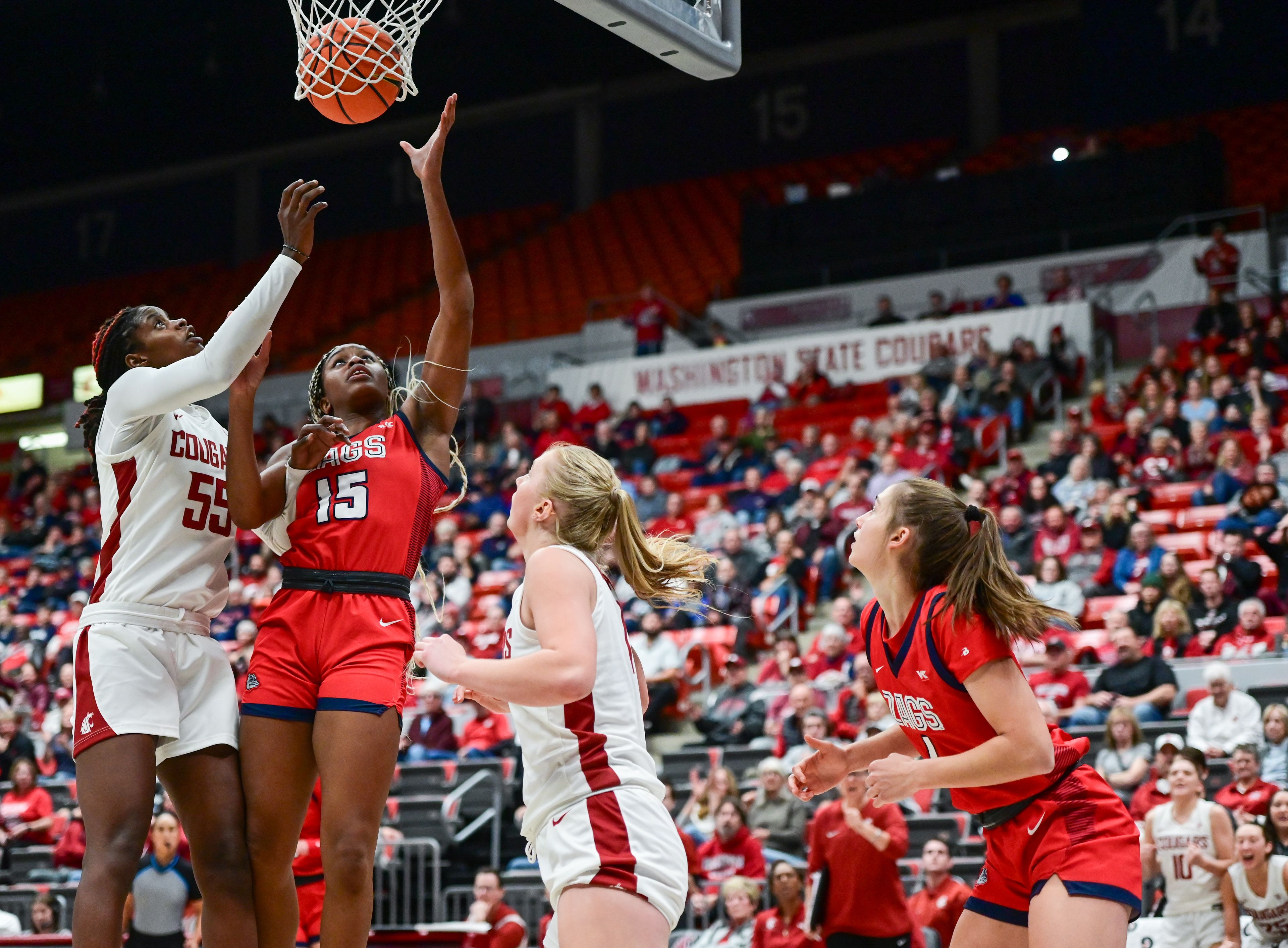 Washington State center Bella Murekatete (55) and Gonzaga forward Yvonne Ejim (15) follow the ball to the net during a game Nov. 9 at Beasley Coliseum.