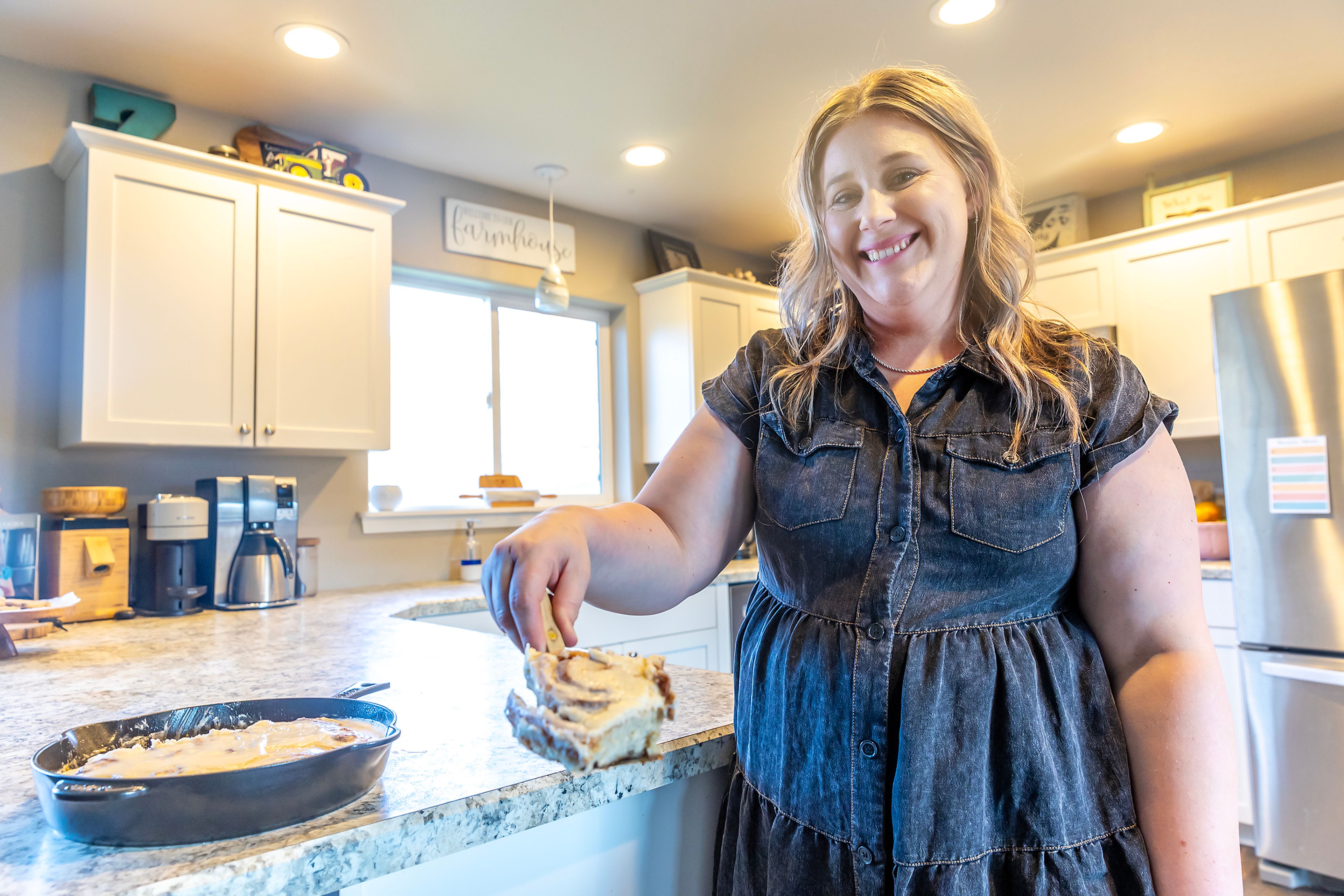 Kayla Zenner holds a sourdough cinnamon roll at her home near Culdesac.