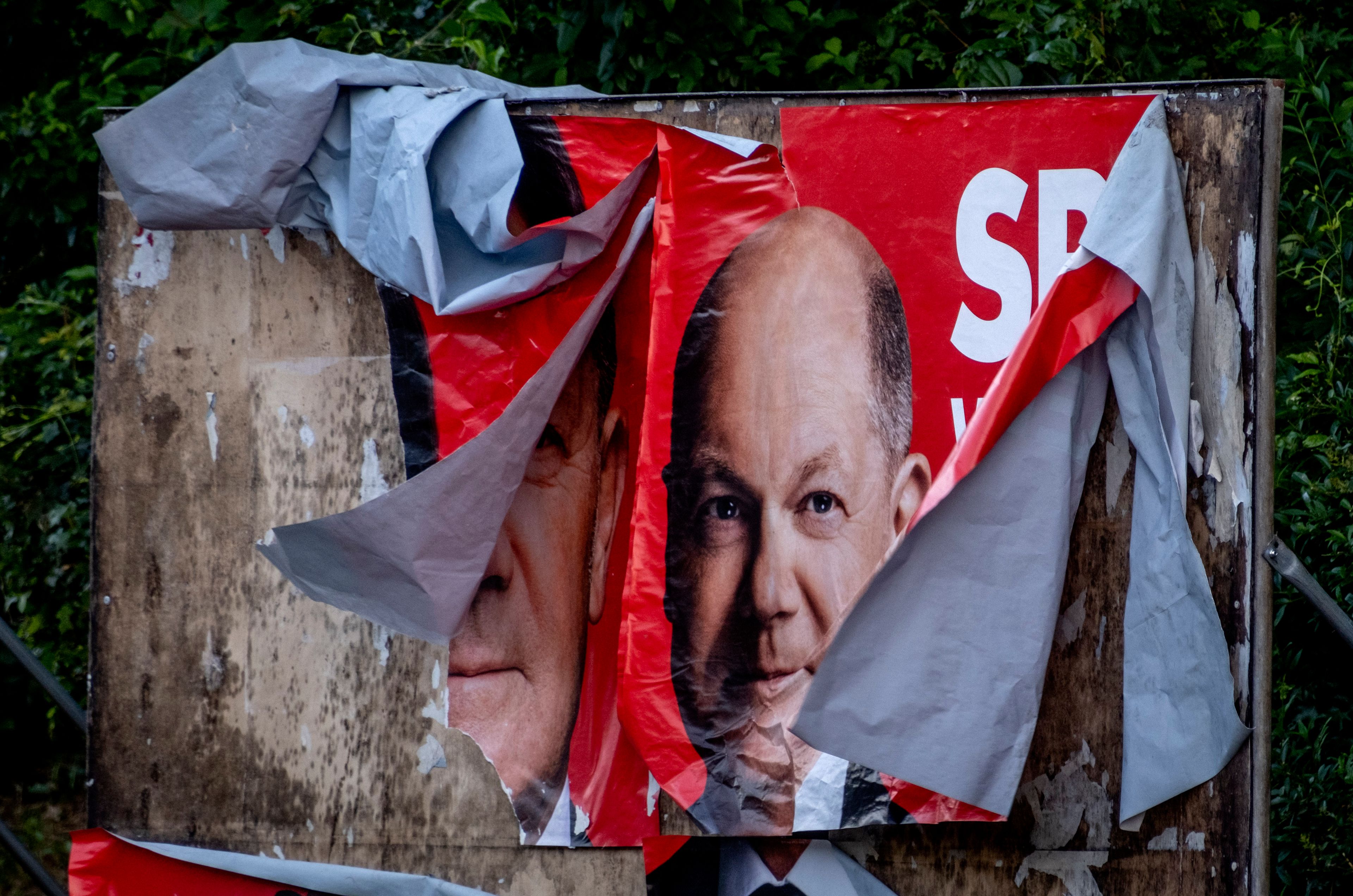 A damaged election poster shows German Chancellor Olaf Scholz in Frankfurt, Germany, Monday, June 10, 2024.