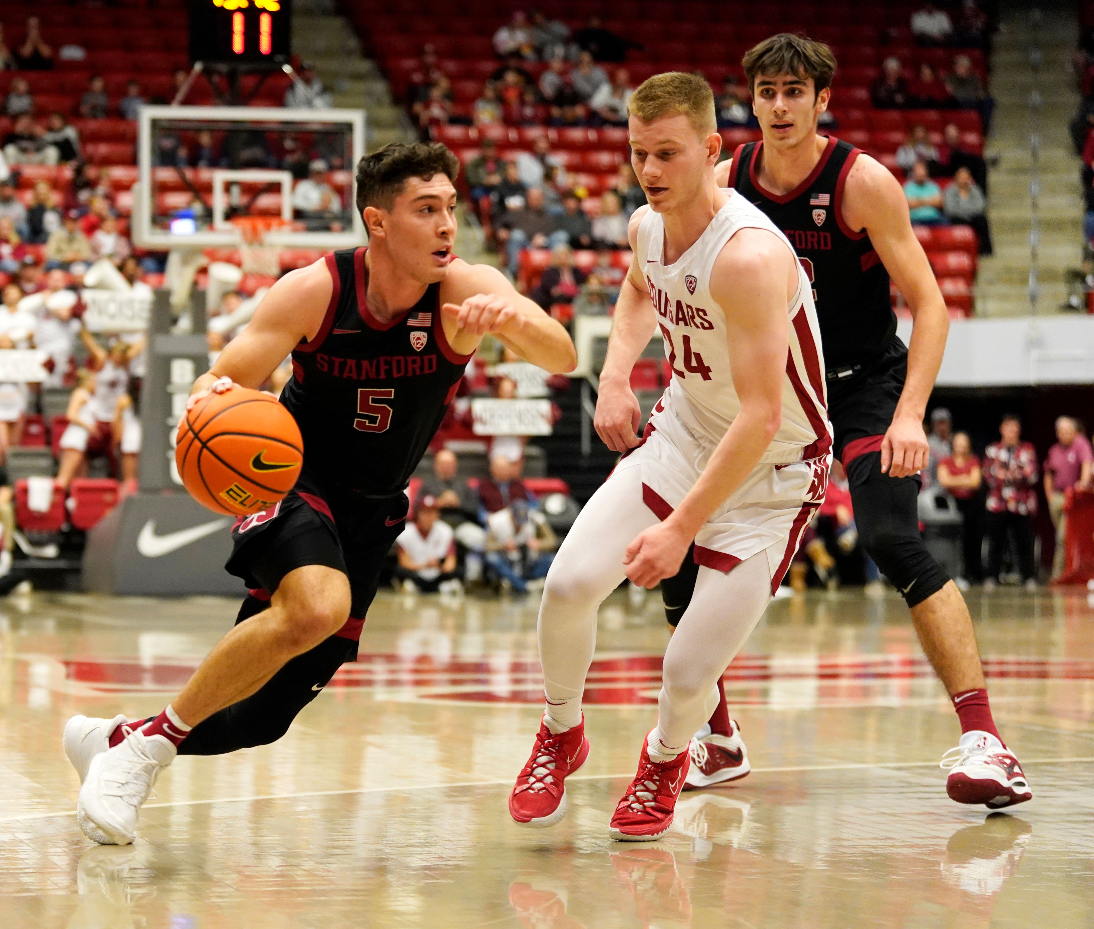 Stanford guard Michael O'Connell (5) drives against Washington State guard Justin Powell (24) during the first half of an NCAA college basketball game in Pullman, Wash., Saturday, Jan. 14, 2023. (AP Photo/Dean Hare)