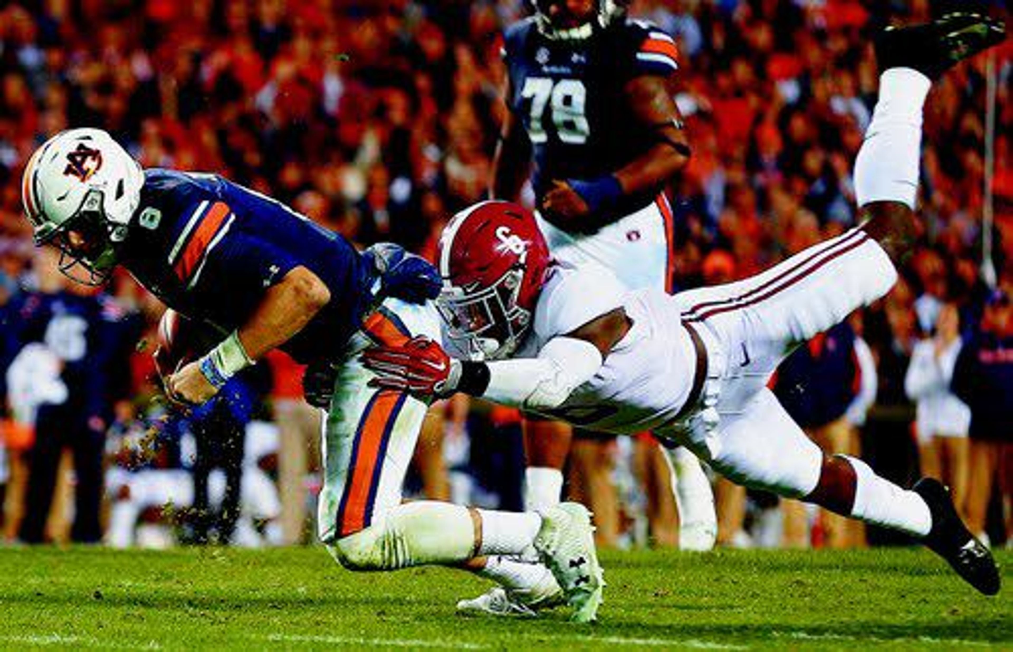 Alabama defensive back Hootie Jones (6) tackles Auburn quarterback Jarrett Stidham (8) during the second half of the Iron Bowl. The Tigers beat the Tide 26-14 on Saturday.