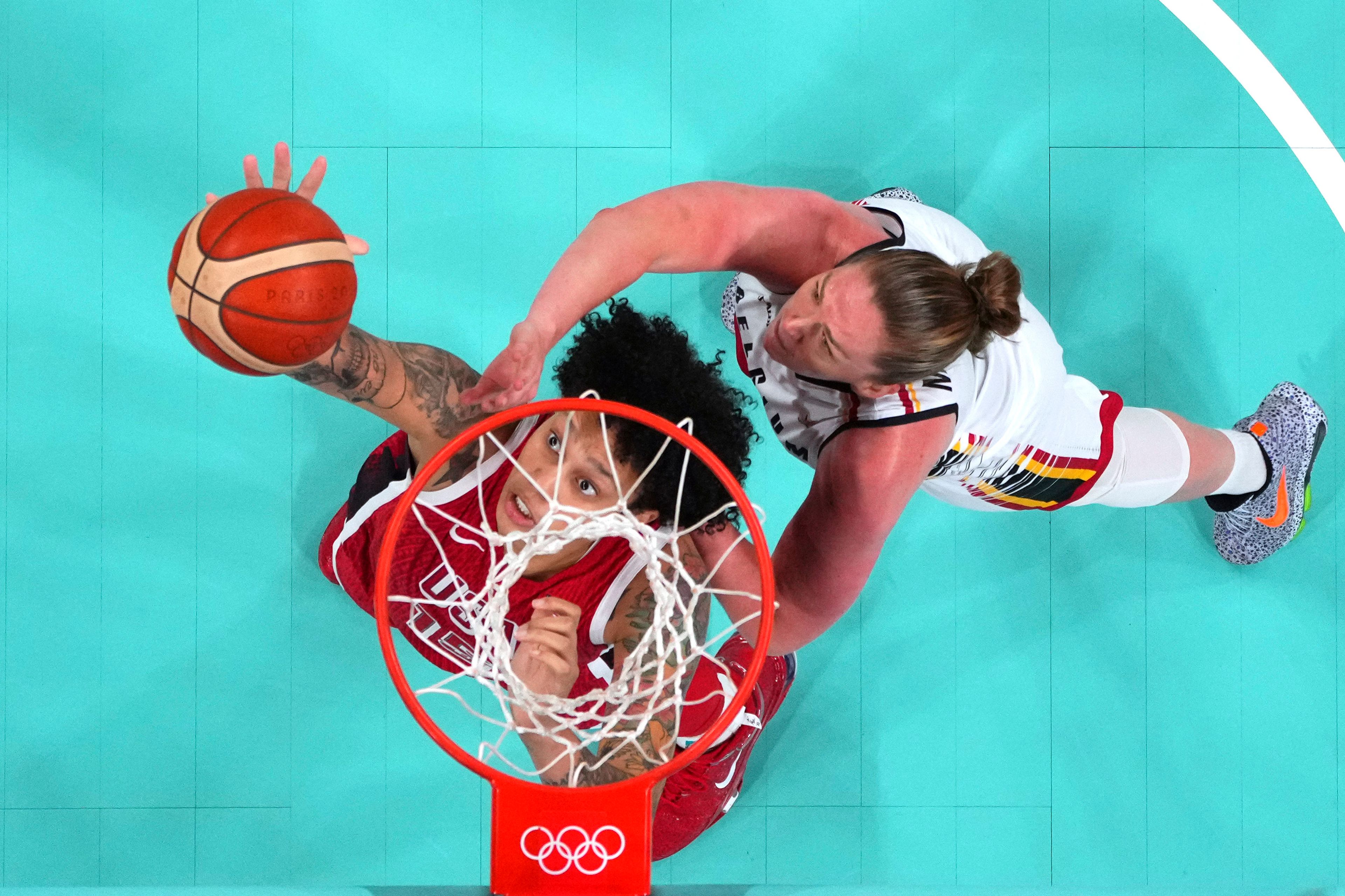 United States' Brittney Griner, left, and Belgium's Emma Meesseman reach for a rebound in a women's basketball game at the 2024 Summer Olympics, Thursday, Aug. 1, 2024, in Villeneuve-d'Ascq, France. (Evelyn Hockstein/Pool Photo via AP)