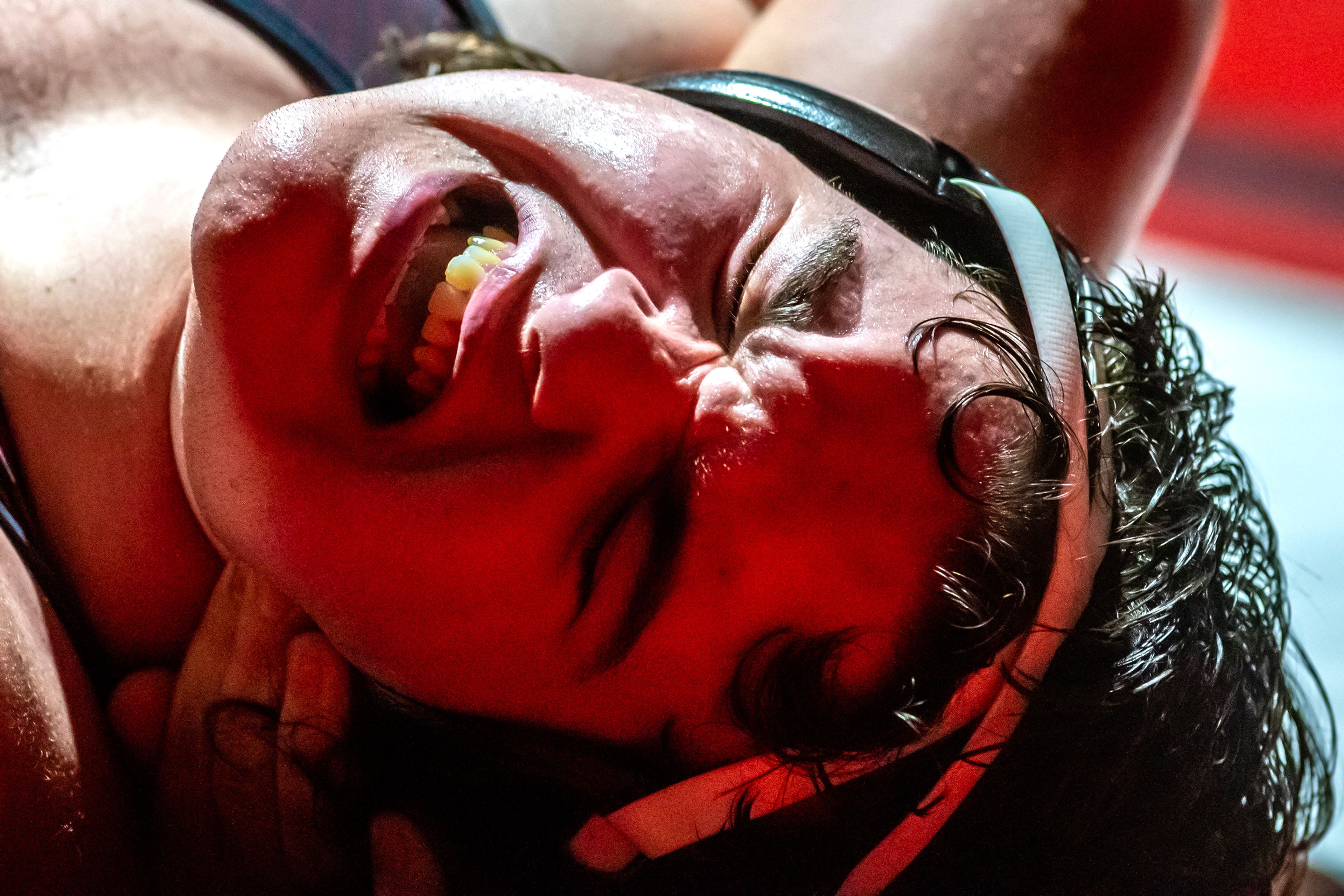 Clarkston’s Justyn Watters grimaces as he’s pinned by Logan Leeson in the 285 pound weight class match during a wrestling duel Wednesday at Clarkston.