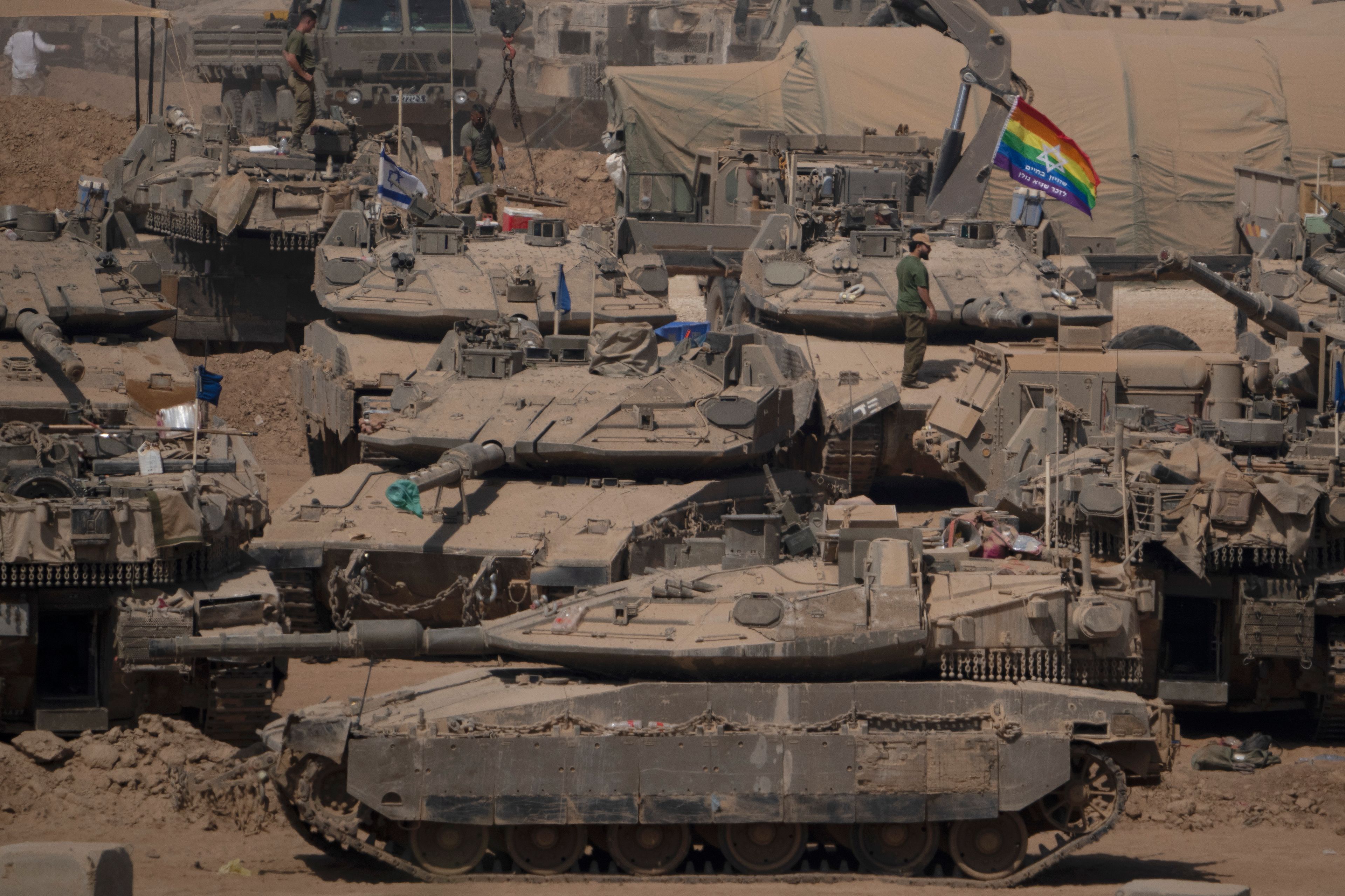 Israeli soldiers stand on top of tanks in a staging area near the Israeli-Gaza border in southern Israel, Monday, June 3, 2024.