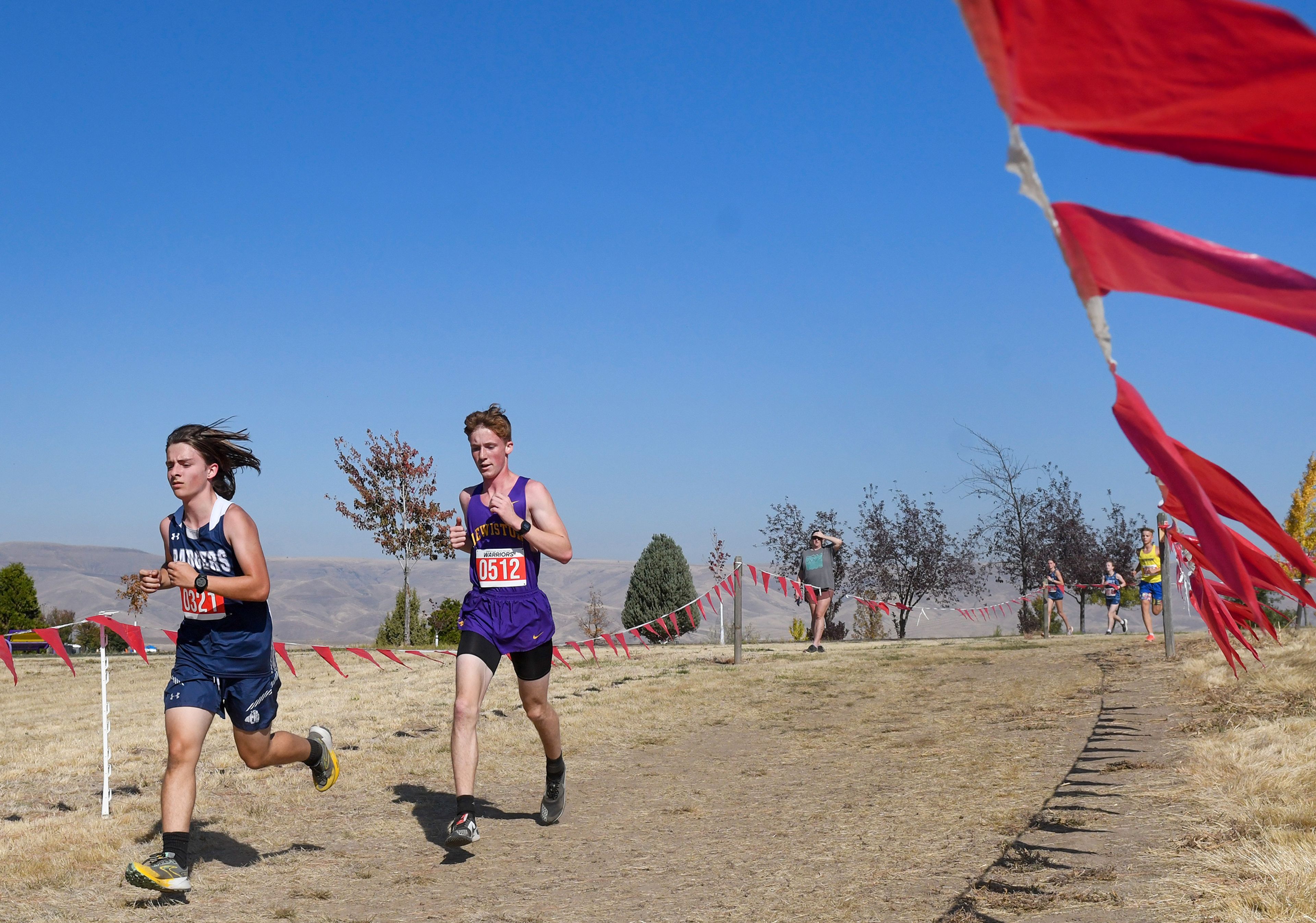 Lewiston's Weston Hoover, right, competes in the Inland Empire Championships varsity boys 5K Saturday along the LCSC XC Course in Lewiston.,