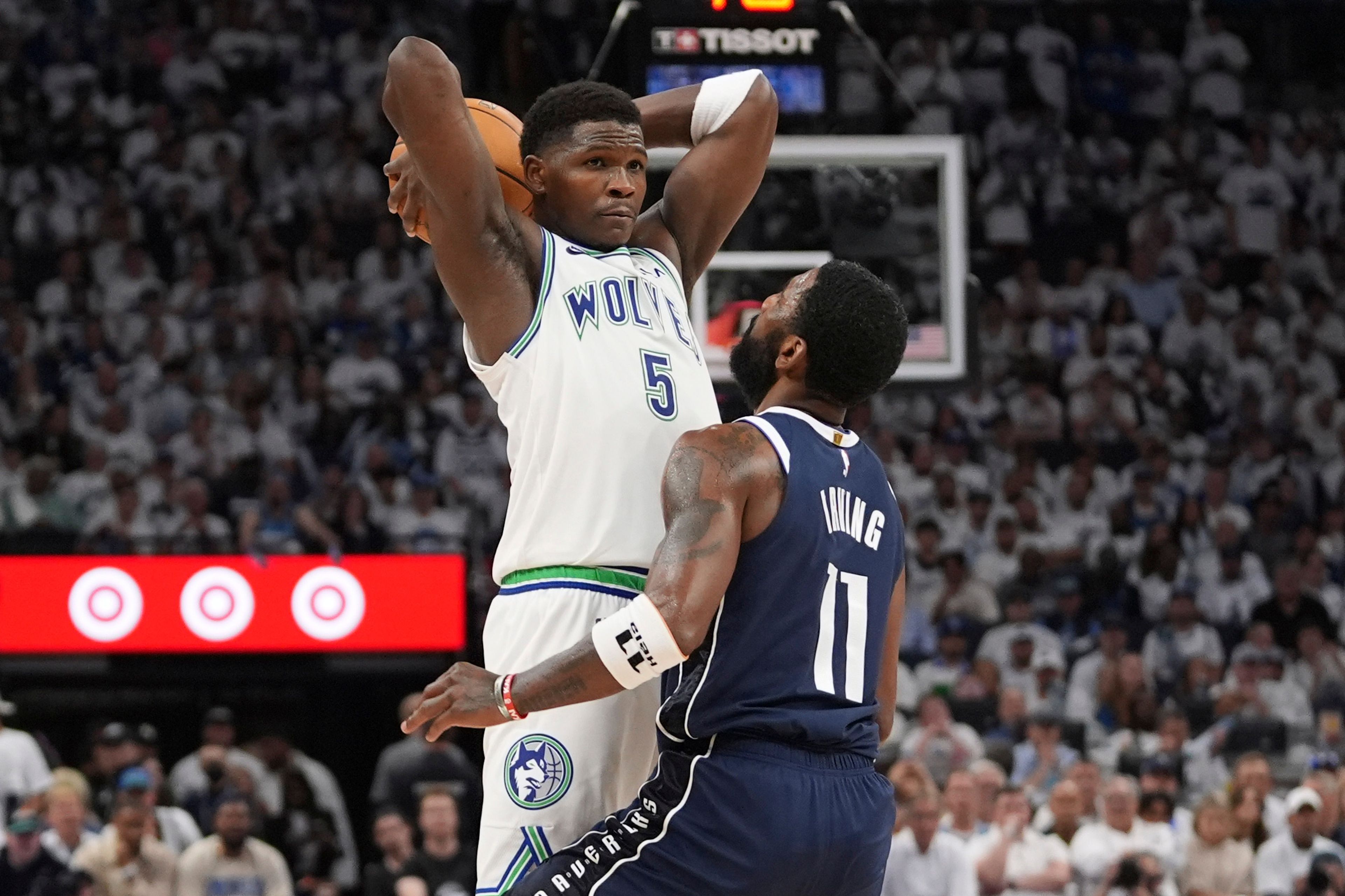 Timberwolves guard Anthony Edwards, left, looks to pass over Mavericks guard Kyrie Irving during the second half in Game 1 of the Western Conference finals Wednesday in Minneapolis.