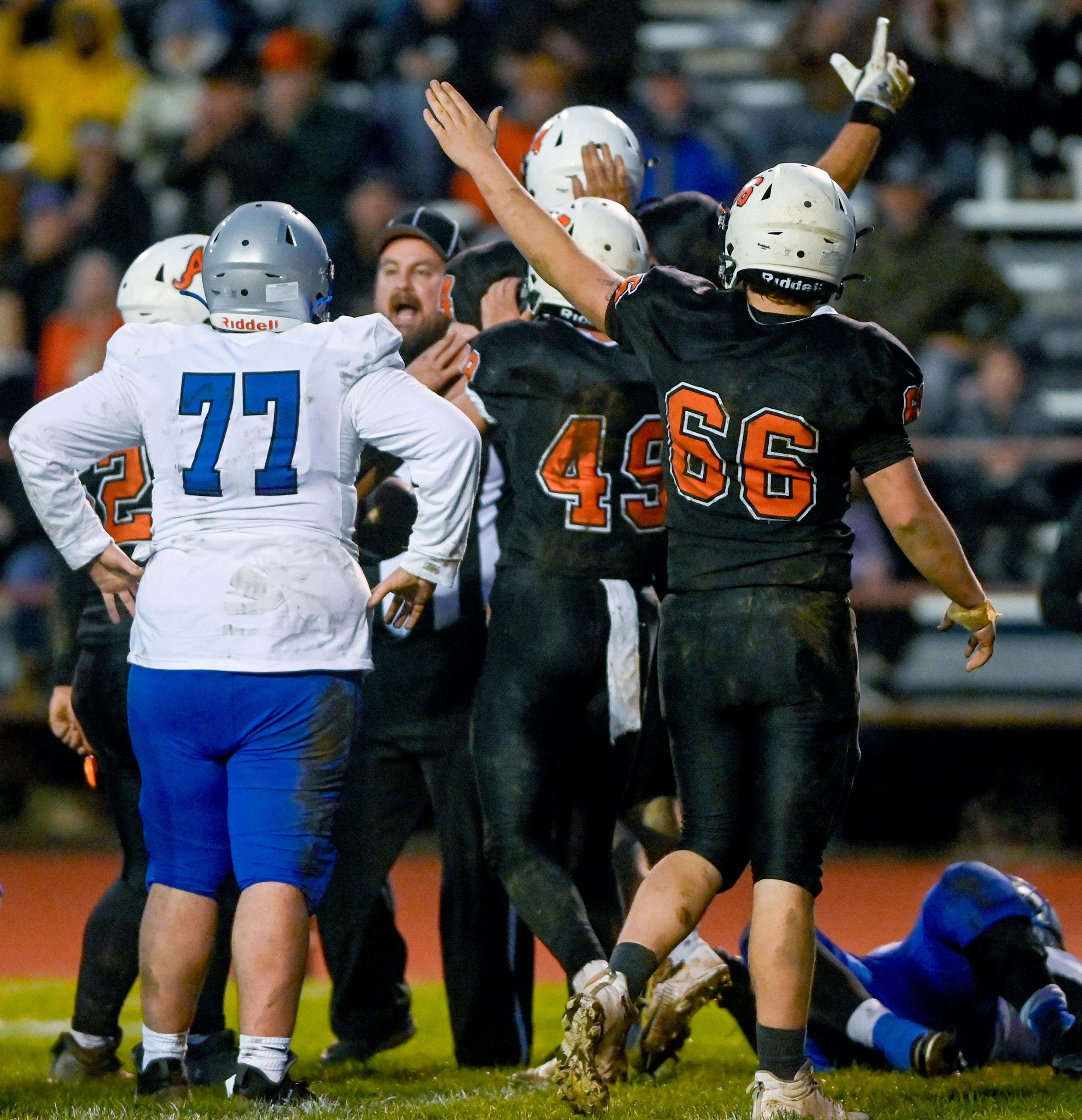 Asotin players raise their arms to signal control of a fumbled La Salle ball Saturday during a Washington 2B state tournament game in Clarkston.