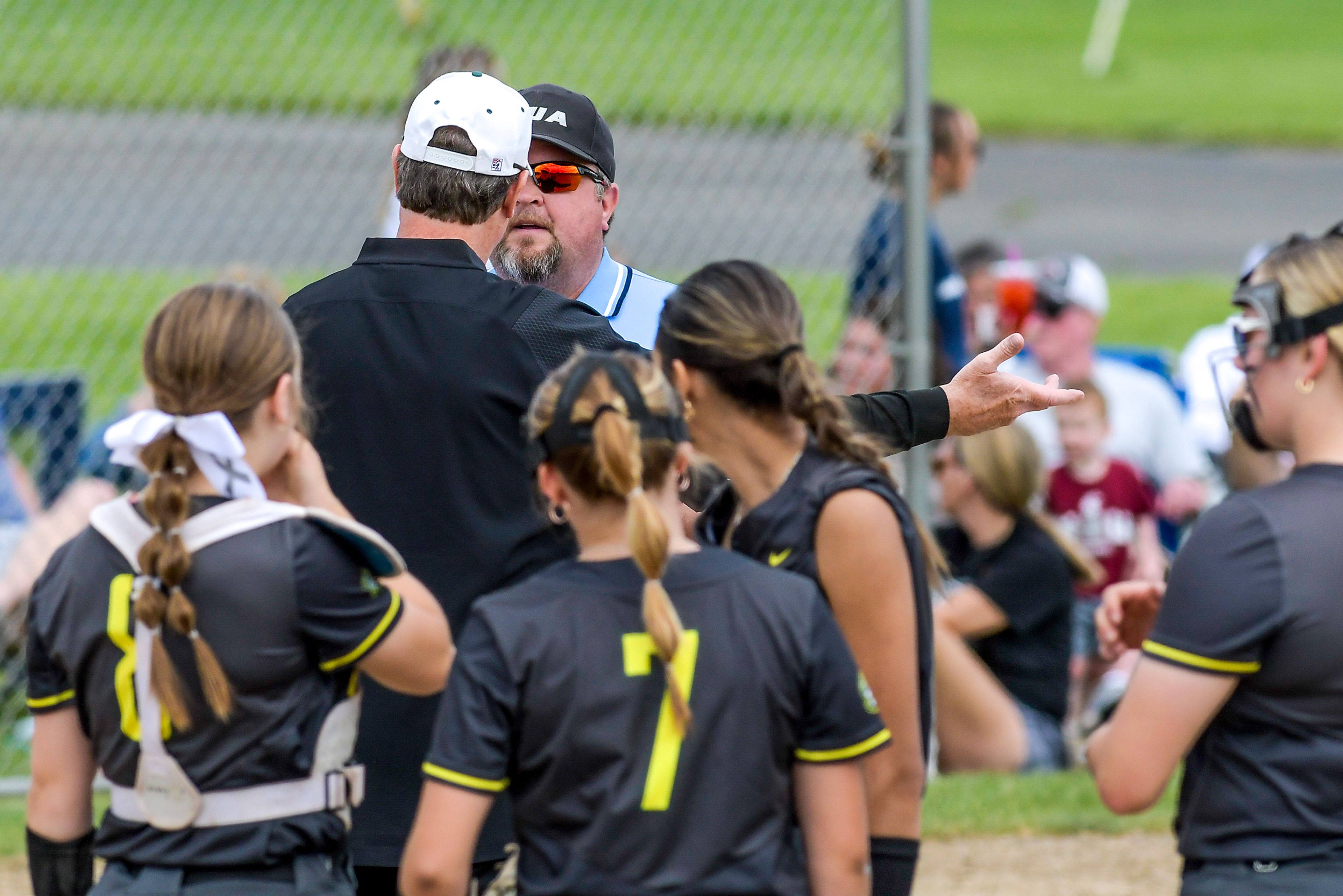 A Shadle Park coach argues with an official during an inning of the District Championship Game Saturday in Clarkston.