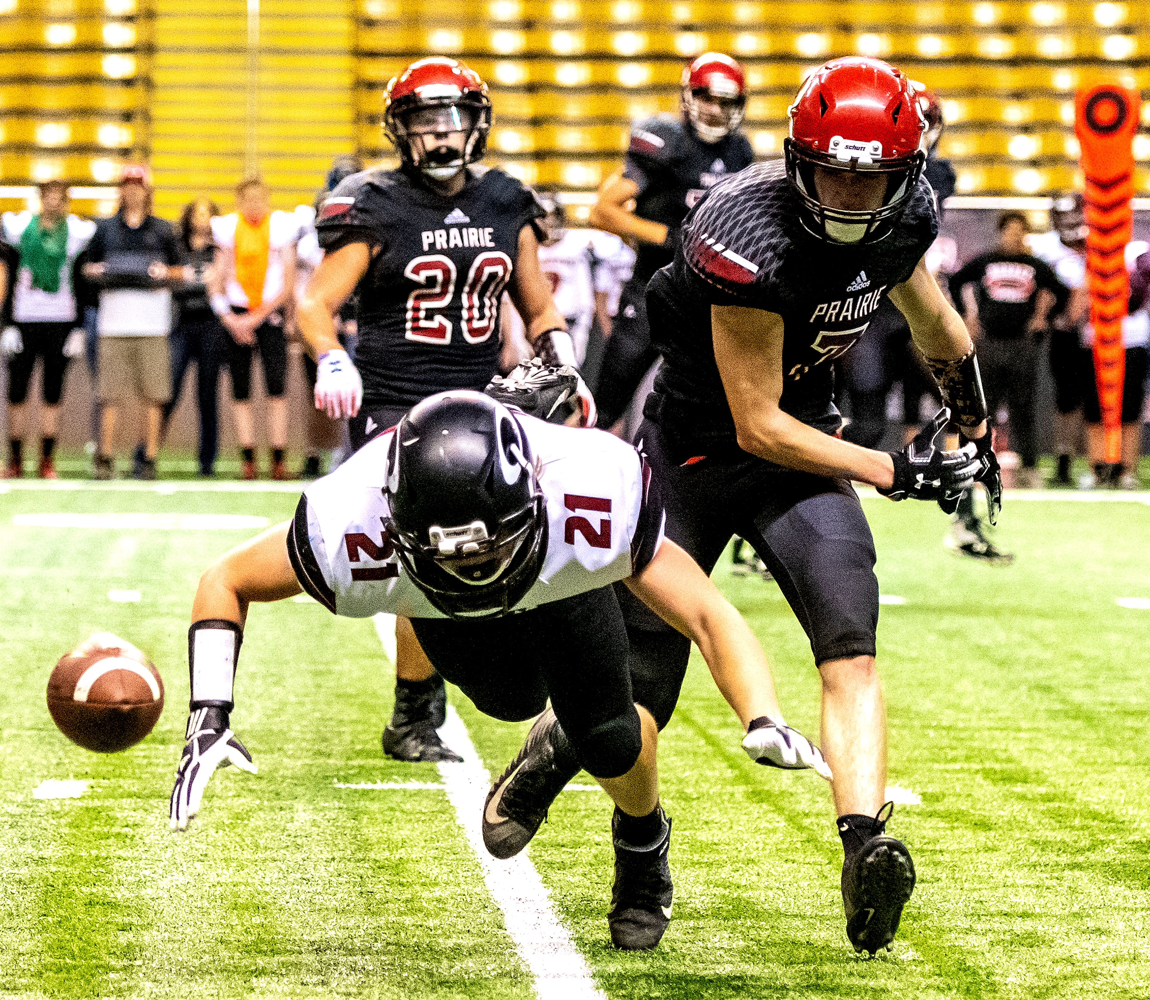 Prairie’s Cole Schlader knocks Oakley’s Robert Wybenga down as he fails to catch the ball. The Prairie Pirates lost to the Oakley Hornets 42-40 in the Class 1A Division O state semifinal football game at the Kibbie Dome in Moscow on Friday.