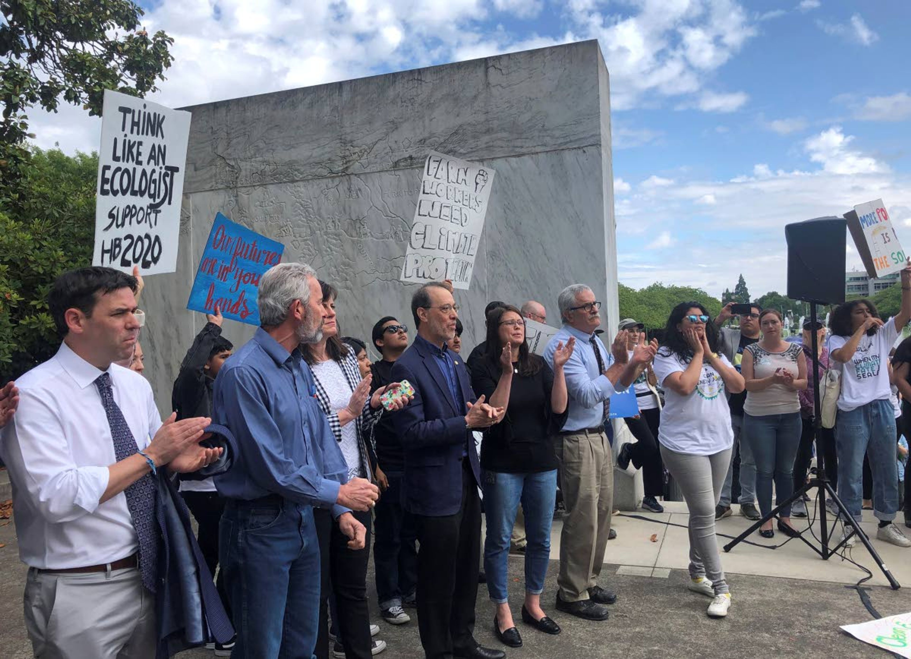 Democratic Senators speak to hundreds of activists protesting a Republican walkout over landmark climate legislation Tuesday, June 25, 2019, in Salem, Ore. The president of the Oregon Senate said Tuesday there weren't enough votes in his majority Democratic caucus to approve a landmark climate bill that has sparked a walkout by Republicans and left other key issues such as the state budget in limbo. (AP Photo/Sarah Zimmerman)