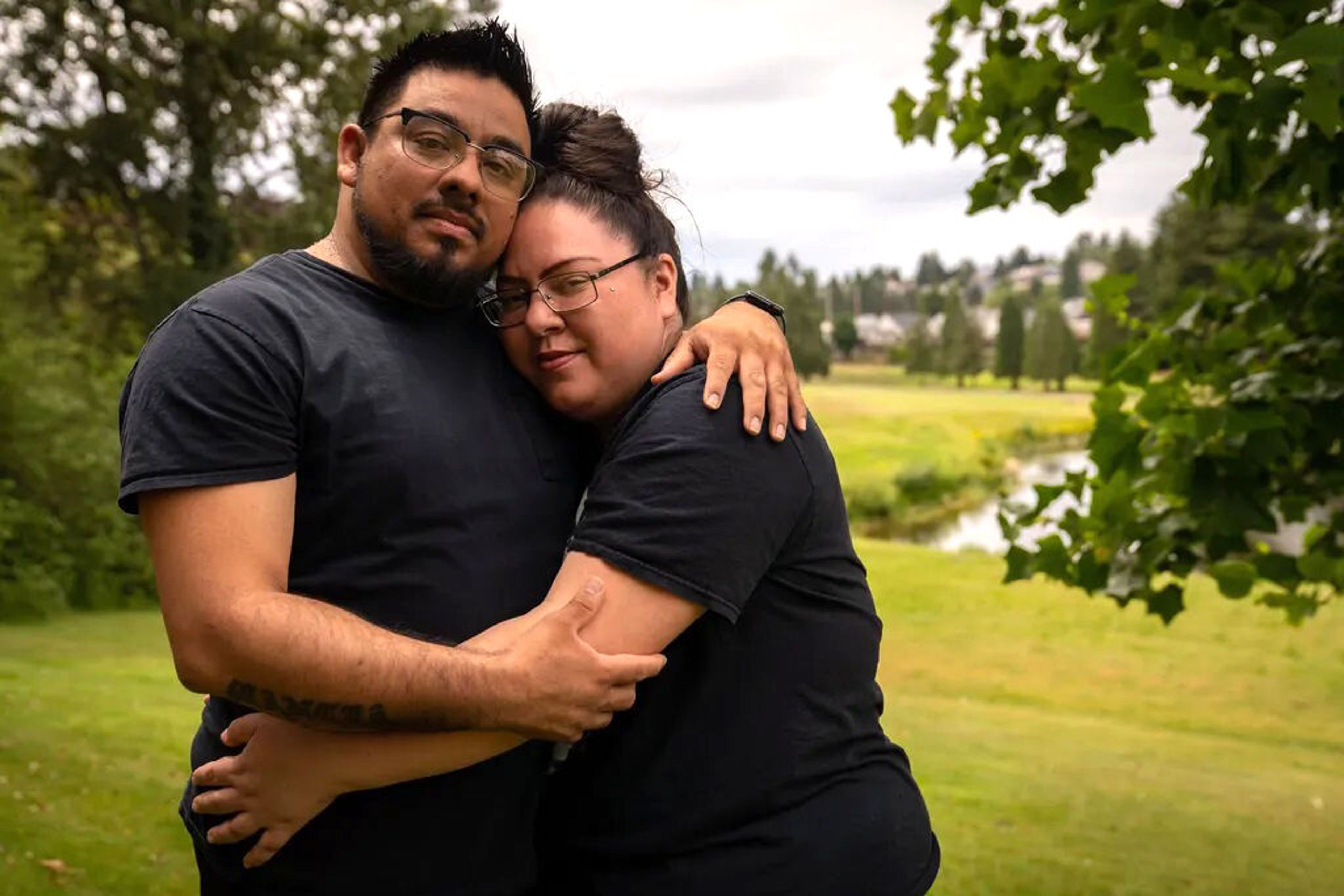 Jarold Mancia and his wife Carleigh pose for a portrait outside of their Tacoma home, where they are raising four children.