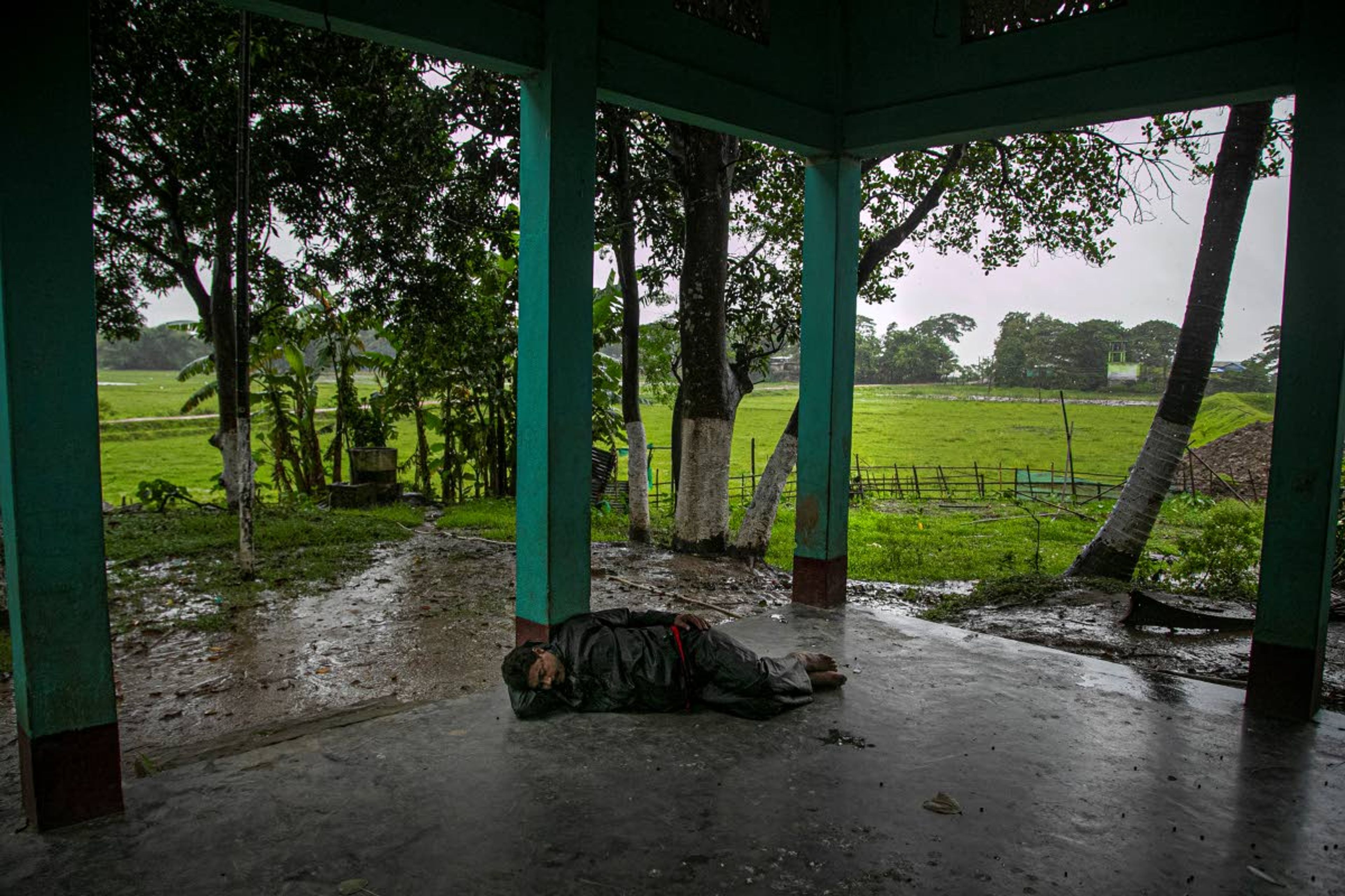 Ramananda Sarkar, 43, rests on the way after making a trip to his village to meet his family, in Diprang village, in the northeastern Indian state of Assam, Tuesday, Sept. 22, 2020. Sarkar, who was deep in debt and desperate for money, took the job of lighting funeral pyres after failing to pay back a loan he'd taken to start selling sugarcane juice on a wooden cart. Dealing with corpses is a stigma that's only been made worse by the coronavirus, which has killed more than 100,000 people in India out of 6.4 million reported infections. After a month and a half of not seeing his wife and three sons, Sarkar snuck into his village in the middle of a recent rainy night and was able to spend 15 minutes with them and leave them some money. (AP Photo/Anupam Nath)