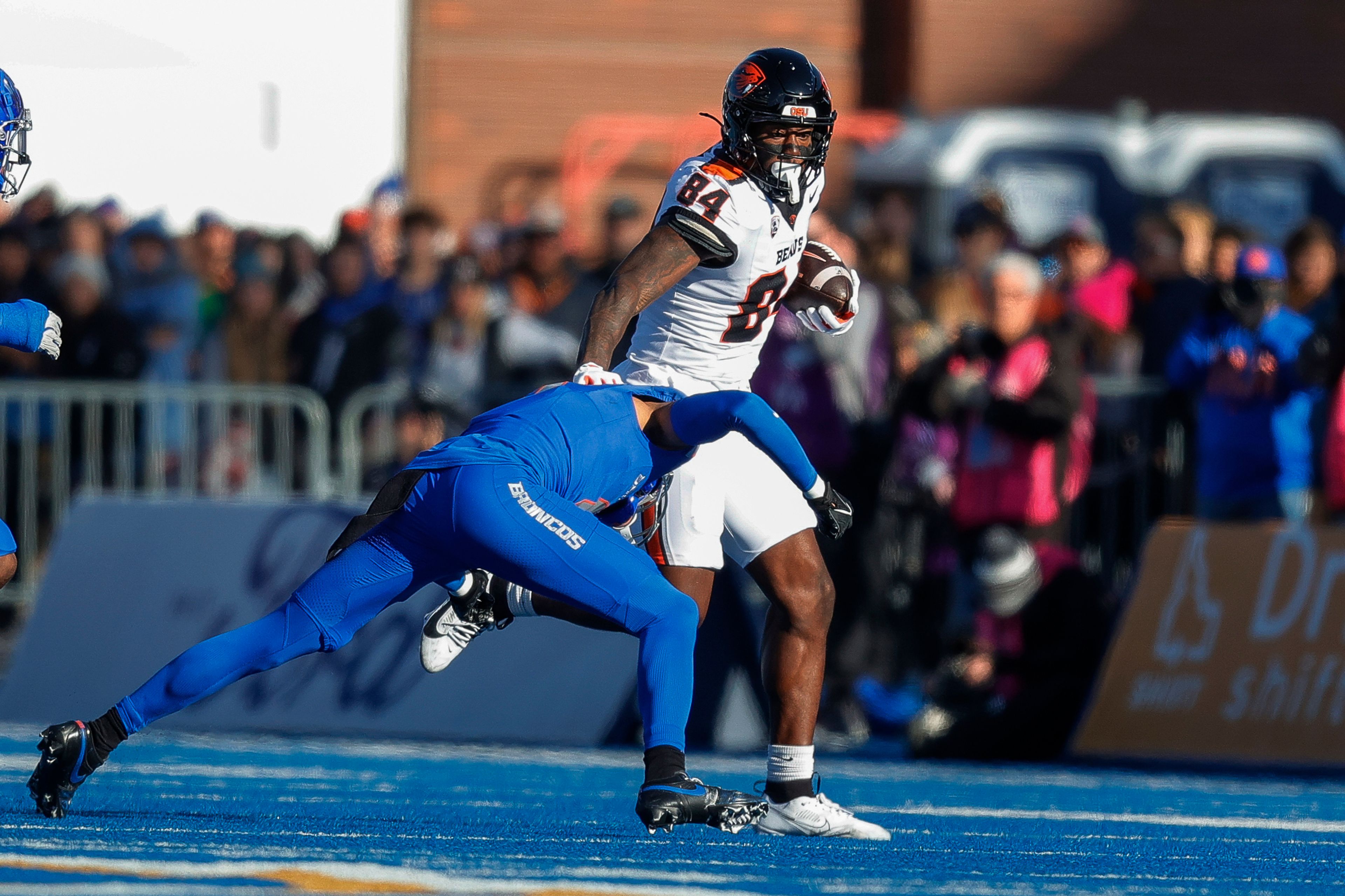 Oregon State tight end Jermaine Terry II (84) runs with the ball after a reception and tries to avoid the tackle by a Boise State defender in the first half of an NCAA college football game, Friday, Nov. 29, 2024, in Boise, Idaho. (AP Photo/Steve Conner)