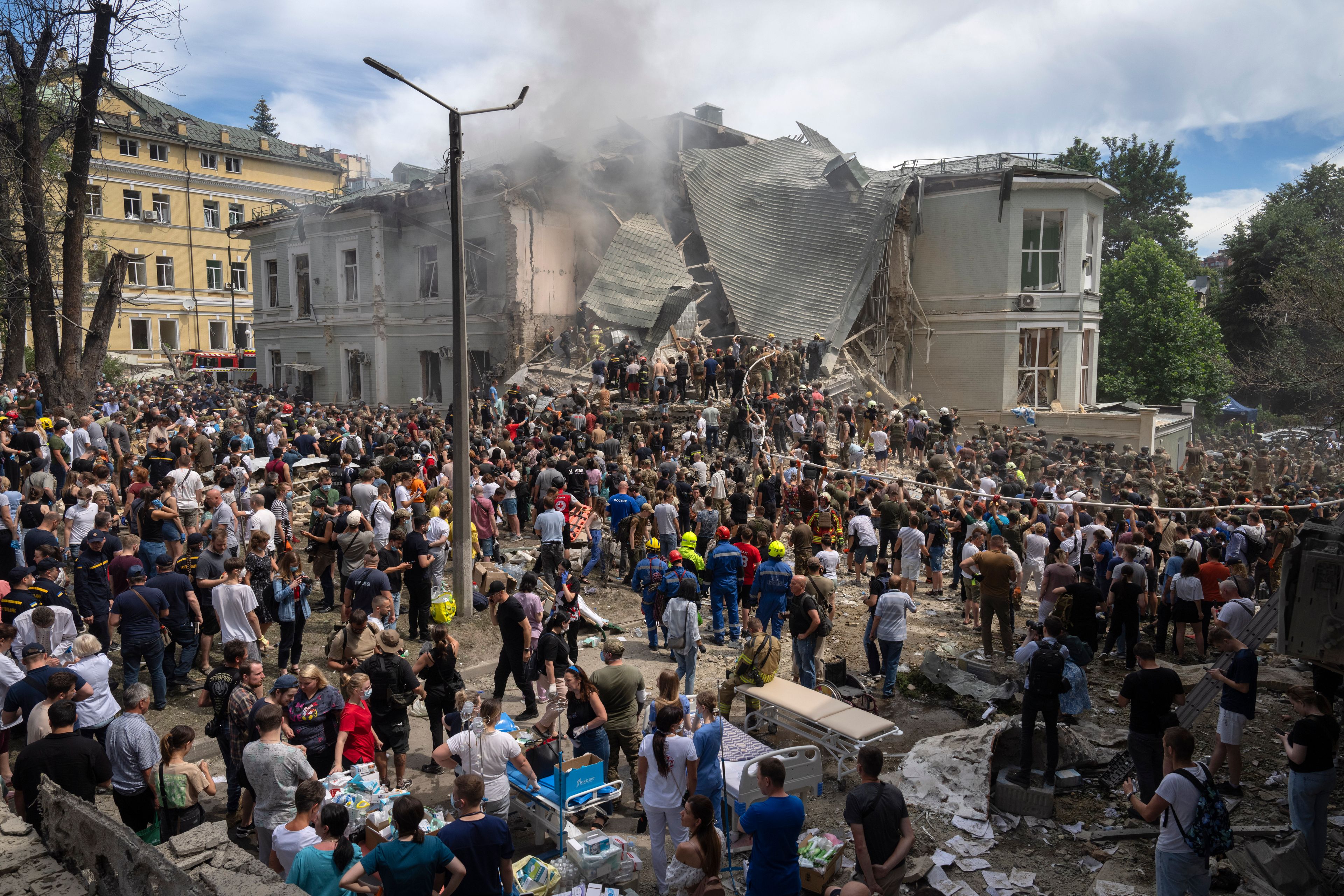 Rescuers and volunteers clean up the rubble and search victims after Russian missile hit the country's main children hospital Okhmadit during massive missile attack on many Ukrainian cities in Kyiv, Ukraine, Monday, July 8, 2024. A major Russian missile attack across Ukraine killed at least 20 people and injured more than 50 on Monday, officials said, with one missile striking a large childrenâ€™s hospital in the capital, Kyiv, where emergency crews searched rubble for casualties. (AP Photo/Efrem Lukatsky)