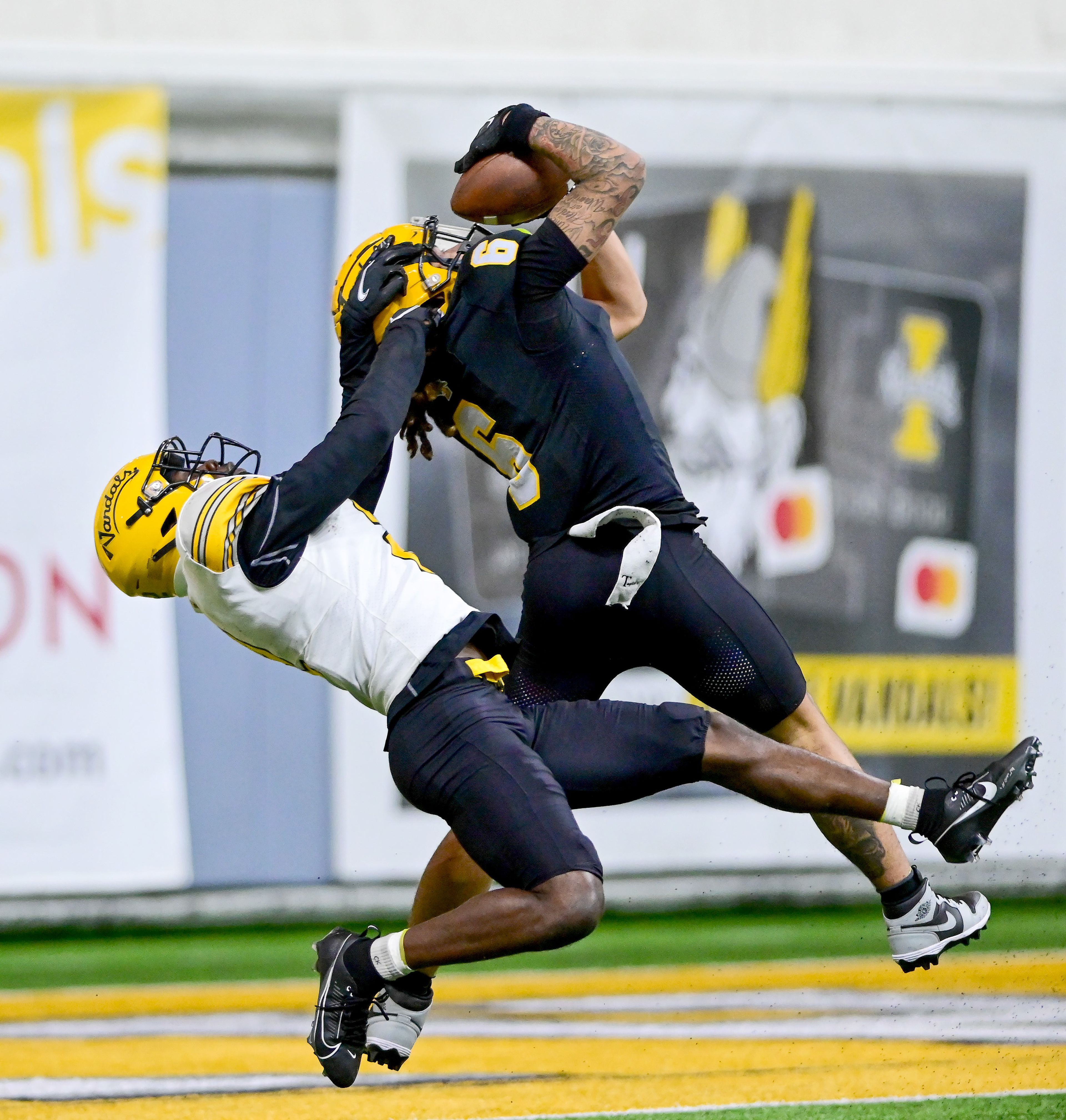 Vandals defensive back Abraham Williams (2) grabs at wide receiver Jordan Dwyer (6) as Dwyer completes a pass in the end zone for a touchdown at the annual spring game April 26 at the P1FCU Kibbie Dome in Moscow.