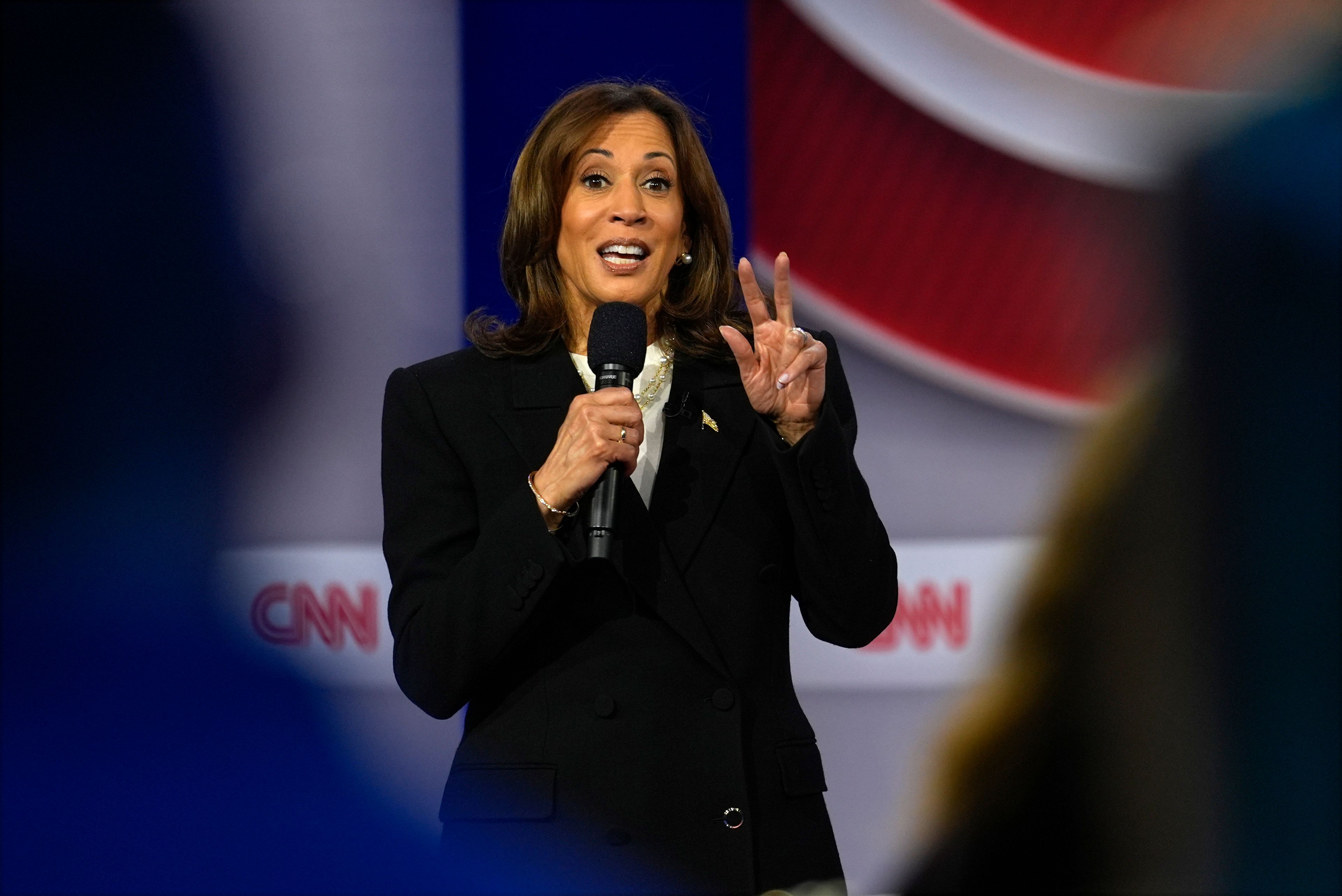 Democratic presidential nominee Vice President Kamala Harris speaks during a CNN town hall in Aston, Pa., Wednesday, Oct. 23, 2024, as moderator Anderson Cooper listens. (AP Photo/Matt Rourke)