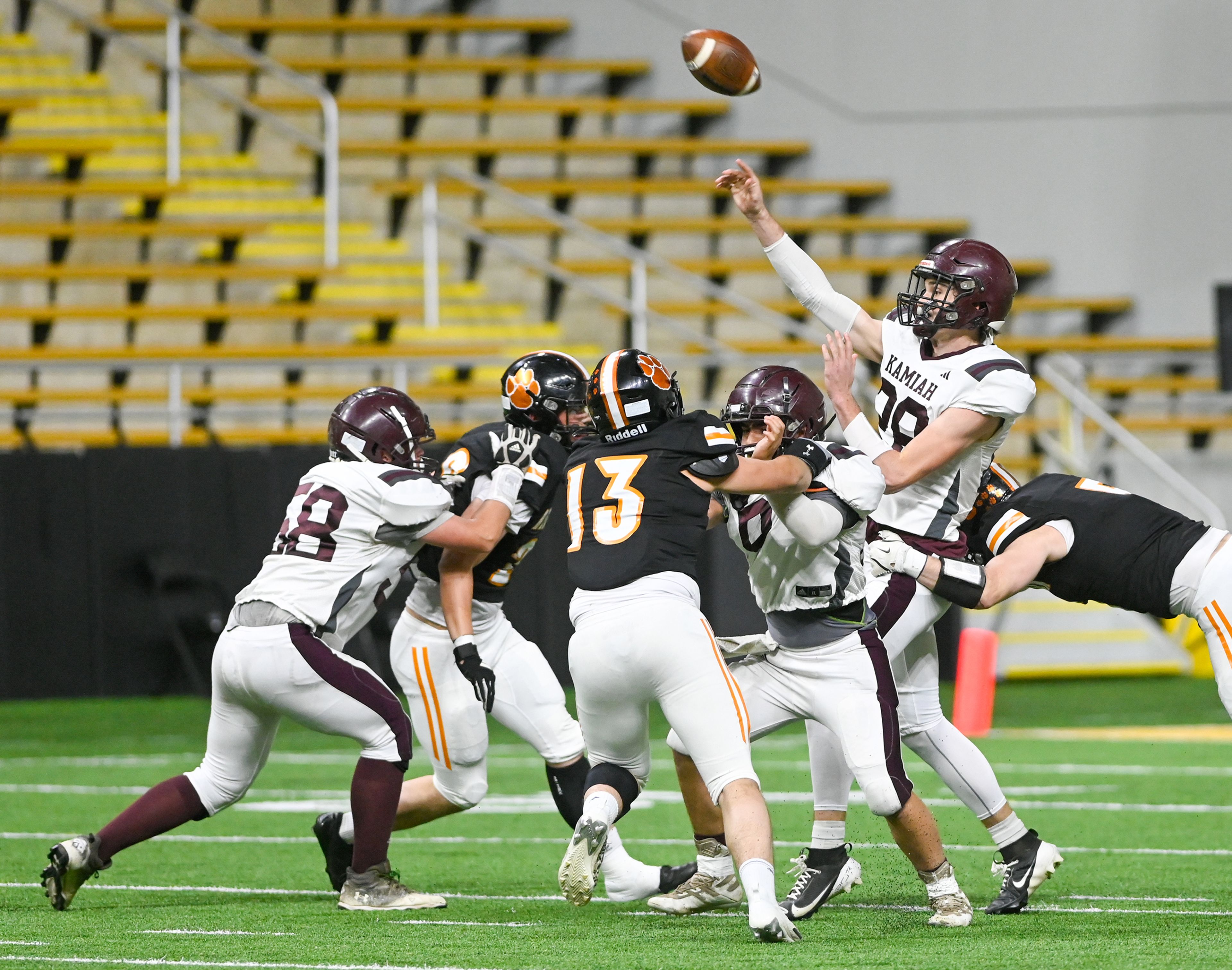 Kamiah’s Dave Kludt throws the ball as Kendrick defenders close in during an Idaho Class 2A state quarterfinal game at the P1FCU Kibbie Dome in Moscow.