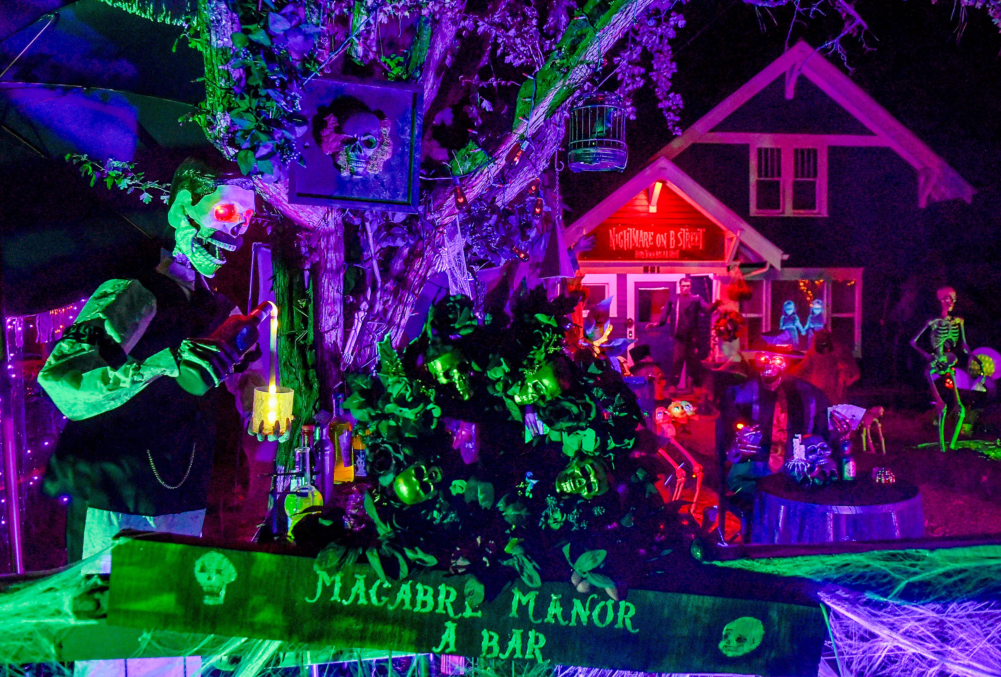 A ghoulish bartender pours a drink from the front corner of the "Nightmare on B Street" themed house along B Street Monday in Moscow. Designed by home owner Chris Perez, a collection of spooky creatures, lights, smoke and more fill the lawn of the home, which will be set up for trick-or-treaters along the street on Halloween.